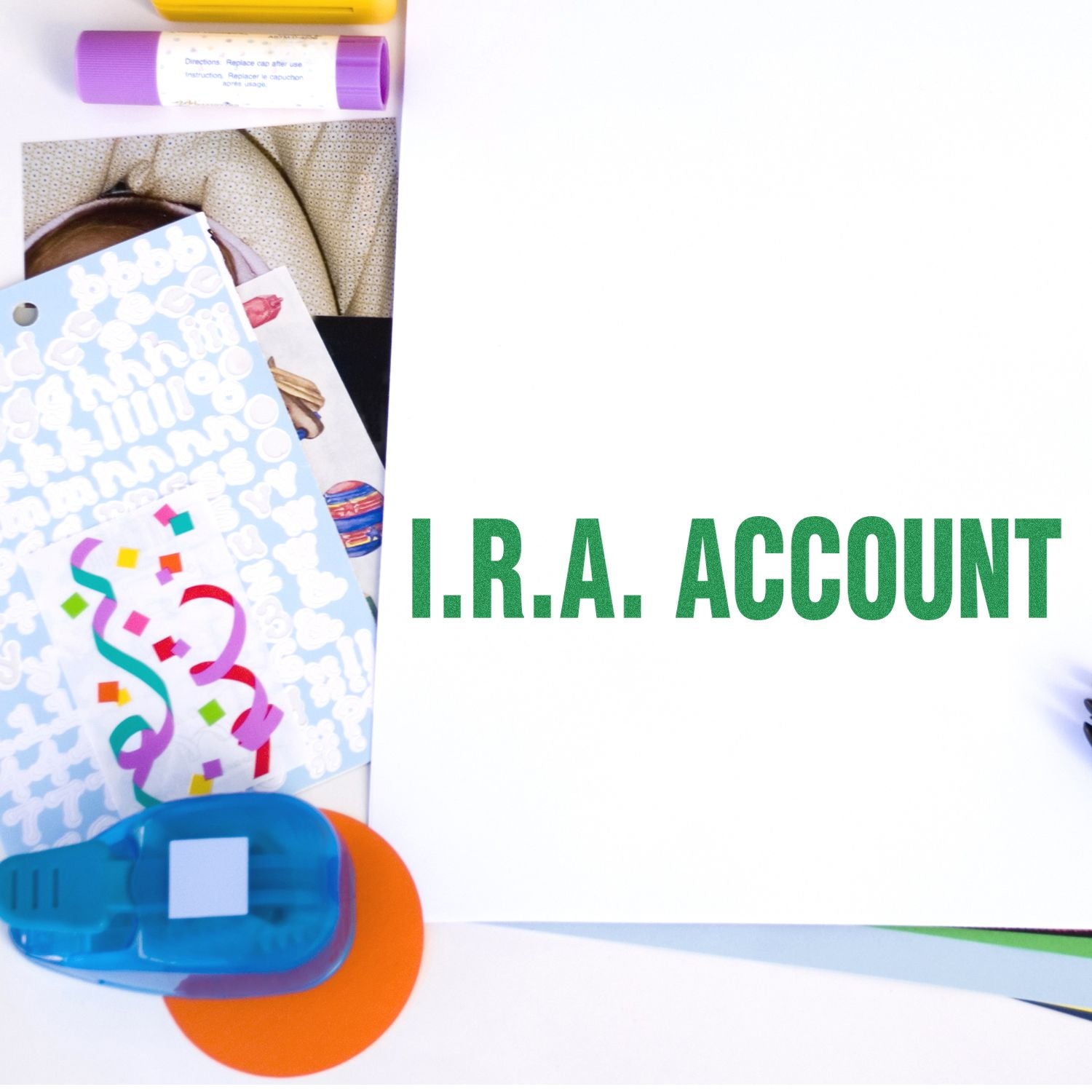 Large I.R.A. Account Rubber Stamp in use on a white paper, surrounded by colorful office supplies and stickers.