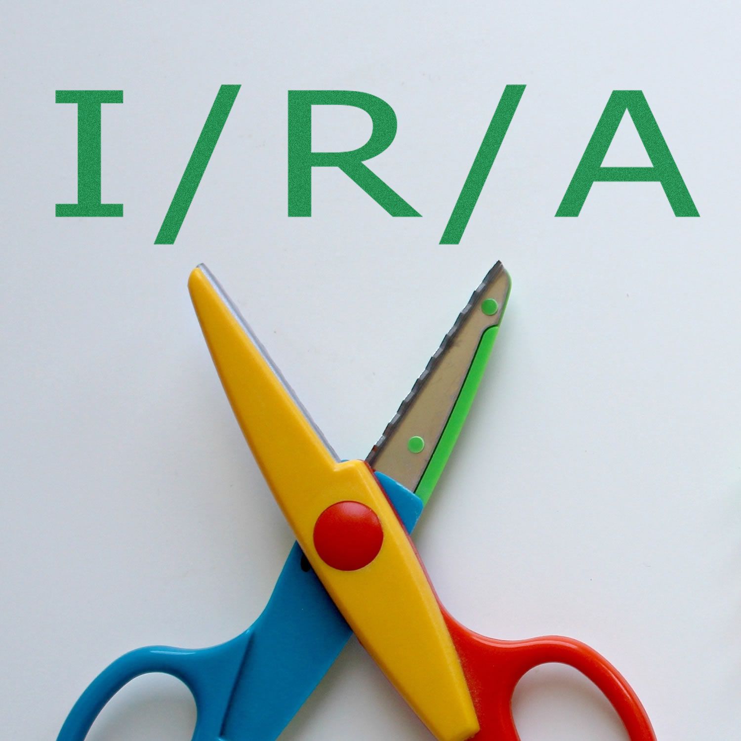 Colorful scissors on a white background with the text I/R/A above them, showcasing the I/R/A Rubber Stamp product.