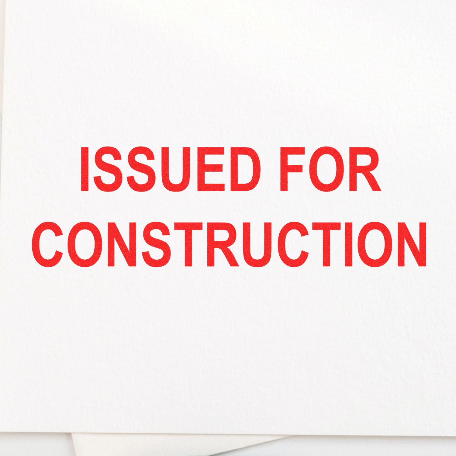 Slim Pre-Inked Issued for Construction Stamp in red ink on white paper, indicating project approval for construction.