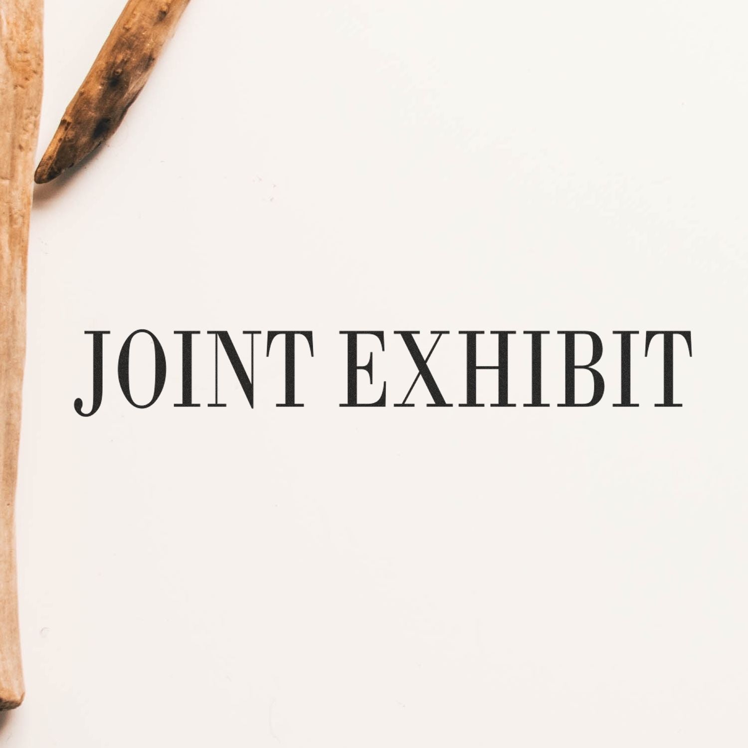 Slim Pre-Inked Joint Exhibit Stamp imprint on white paper, with wooden sticks on the left side.