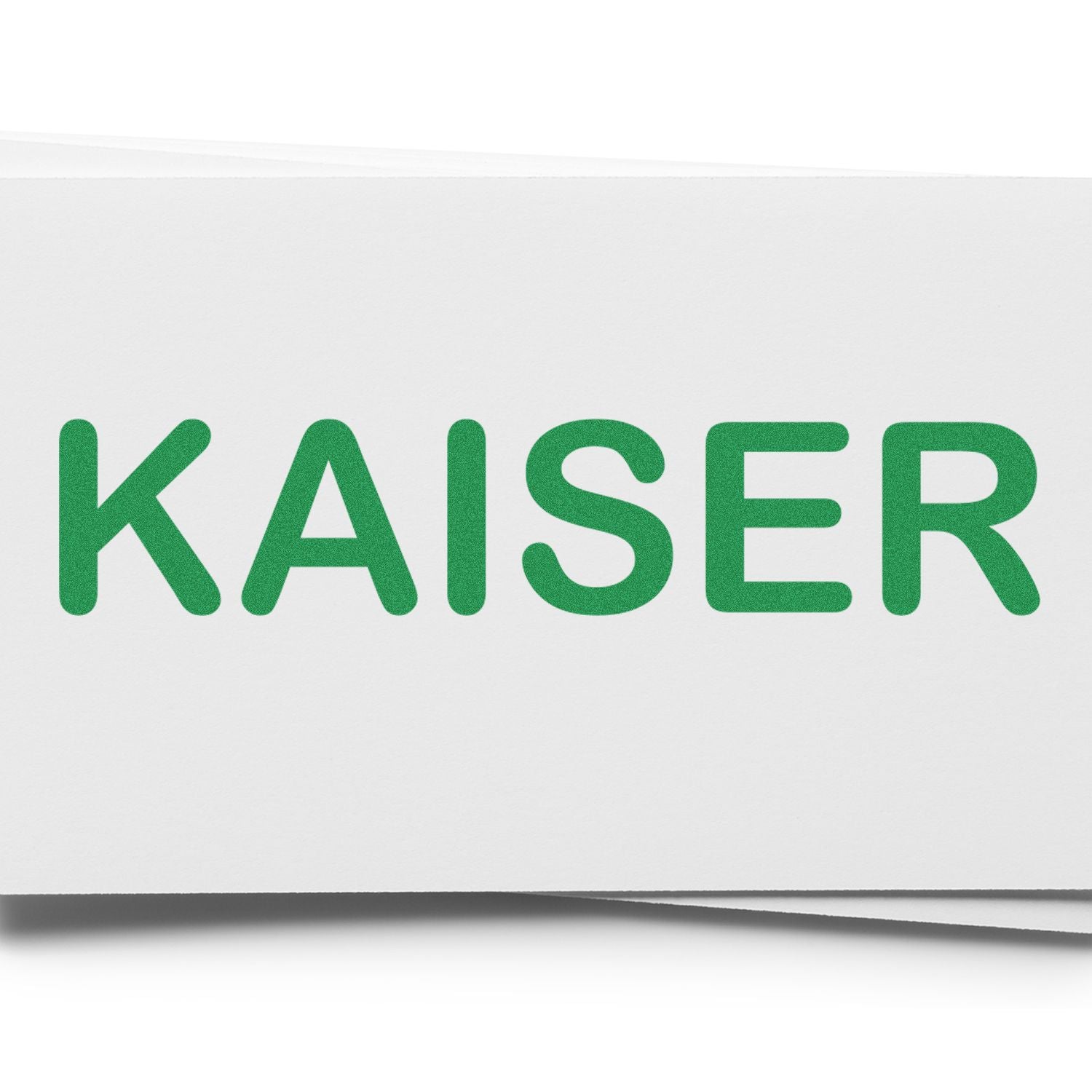 Large Self Inking Kaiser Stamp imprinting the word KAISER in green ink on a white surface.