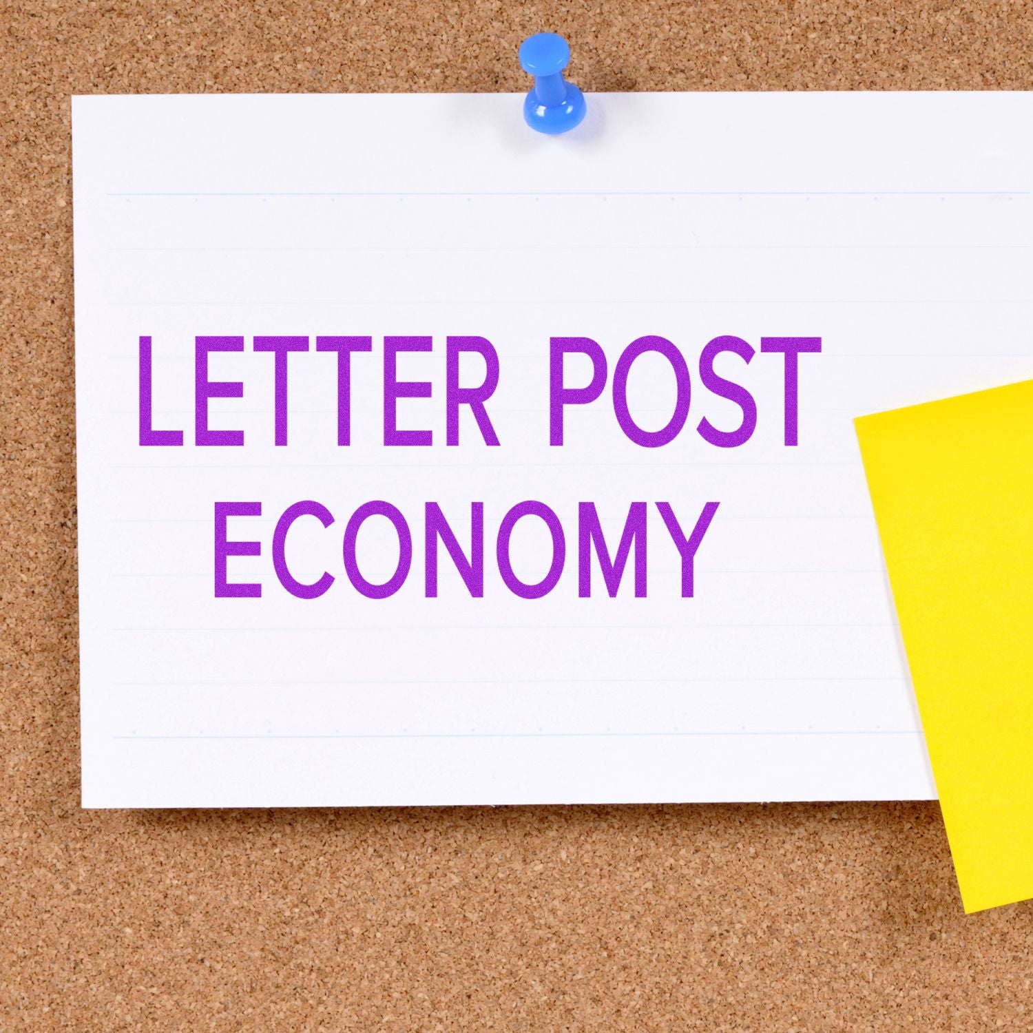 A corkboard with a pinned note displaying LETTER POST ECONOMY stamped in purple using a Slim Pre-Inked Letter Post Economy Stamp.