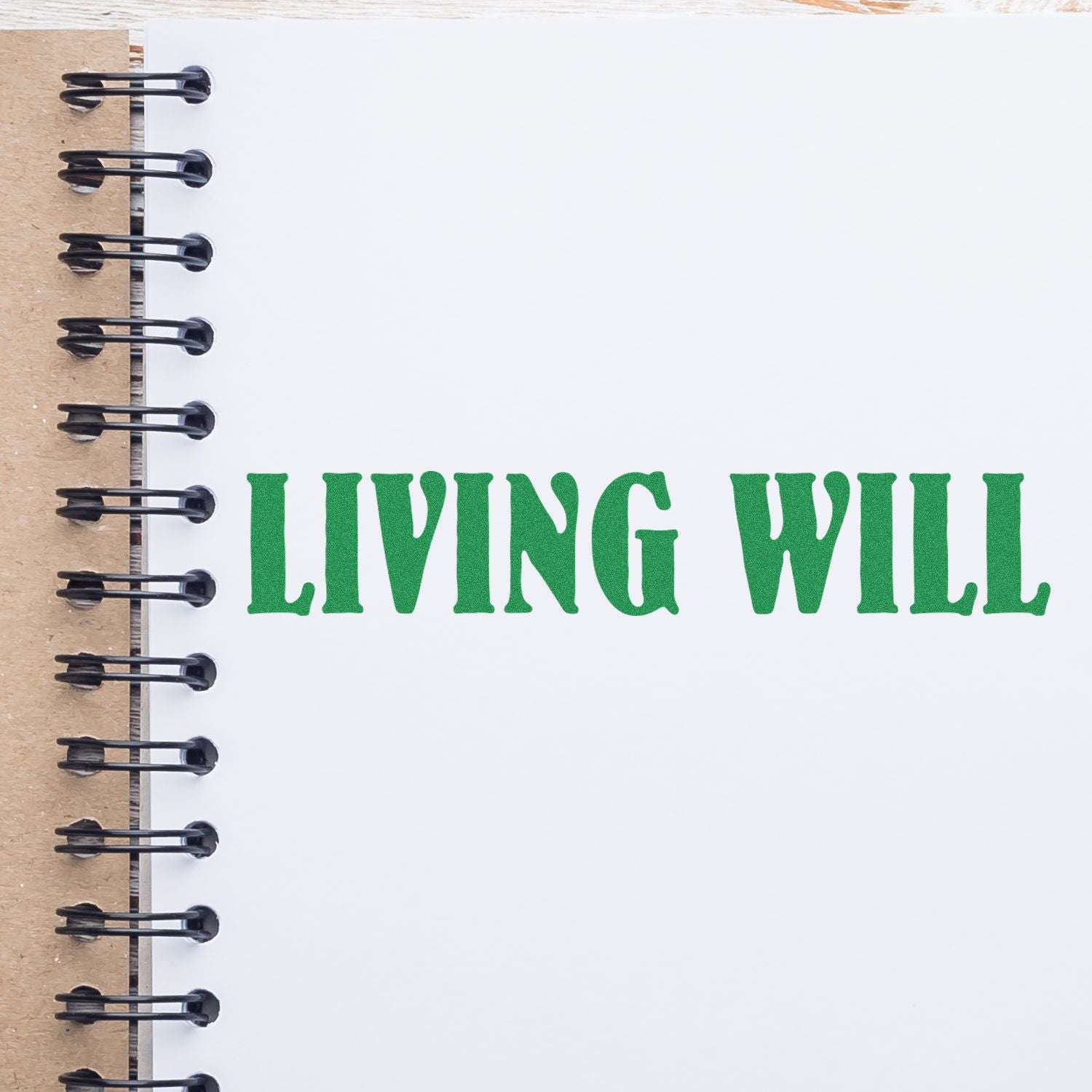 Large Self Inking Living Will Stamp used on white paper in a spiral notebook, displaying the text LIVING WILL in green ink.