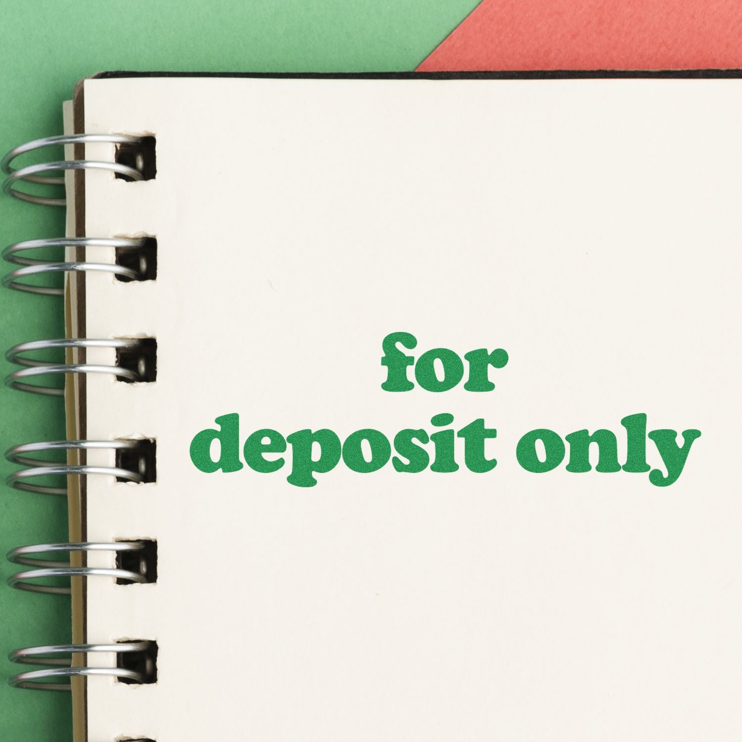 Large Self Inking Lowercase For Deposit Only Stamp used on a white notebook page with green and red background.