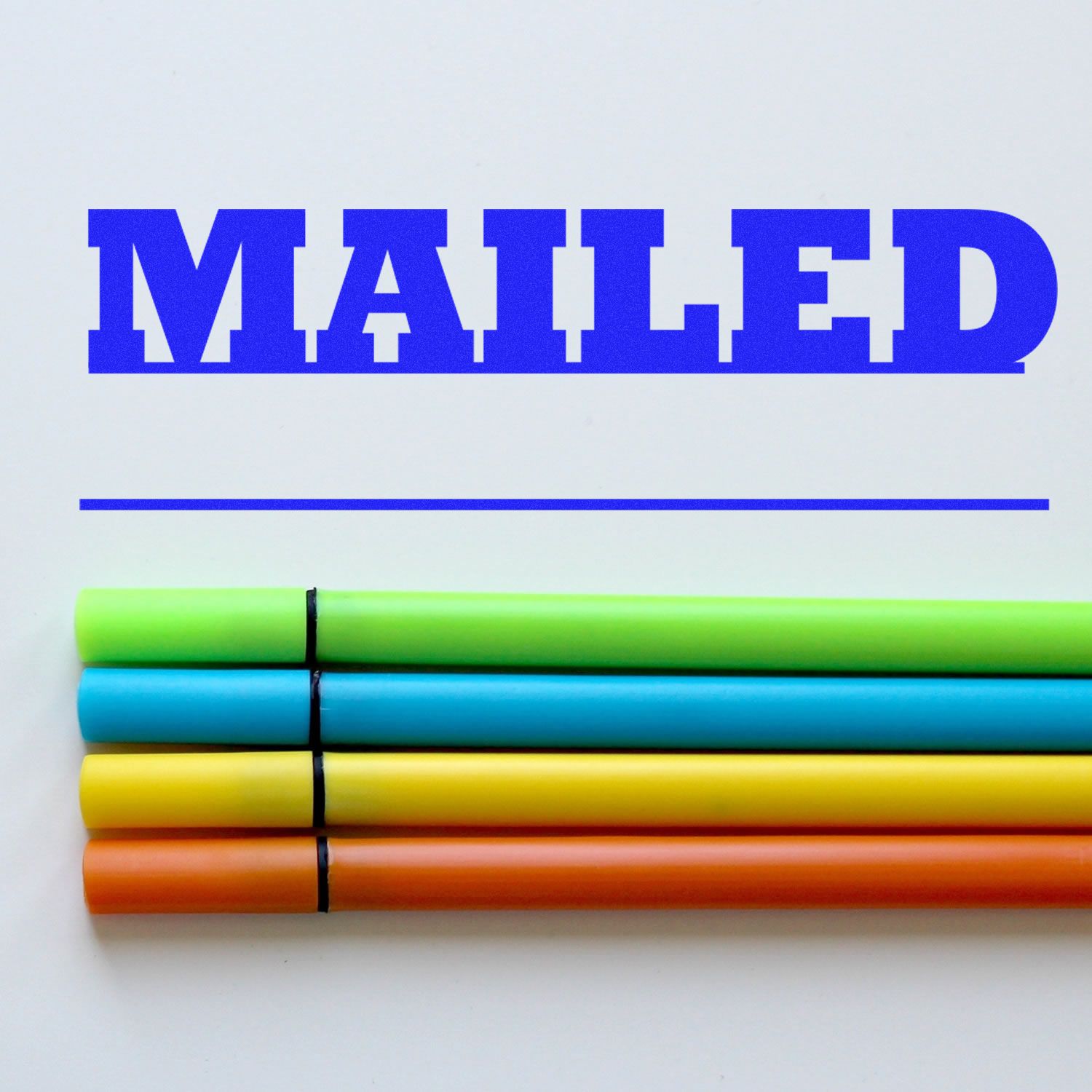 Large Mailed with Date Line Rubber Stamp in blue ink on white paper, with four colorful markers (green, yellow, blue, orange) below the stamped text.