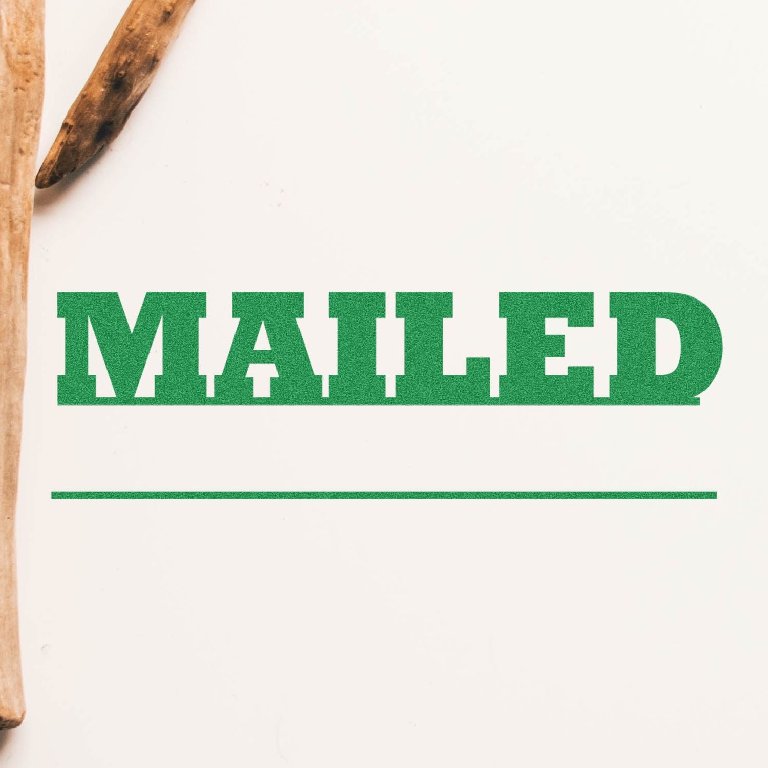 Large Mailed with Date Line Rubber Stamp in green ink on white paper, with a wooden handle partially visible on the left side.