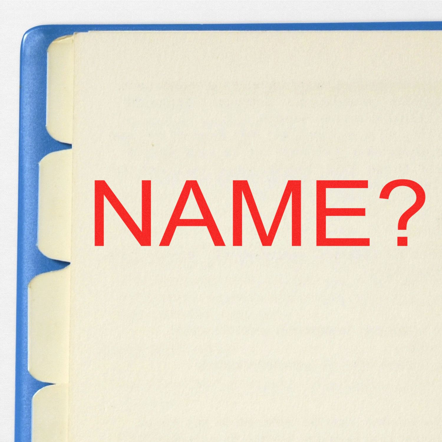 A Large Name Rubber Stamp imprinting NAME? in red ink on a beige tabbed folder, with a blue edge visible on the left side.