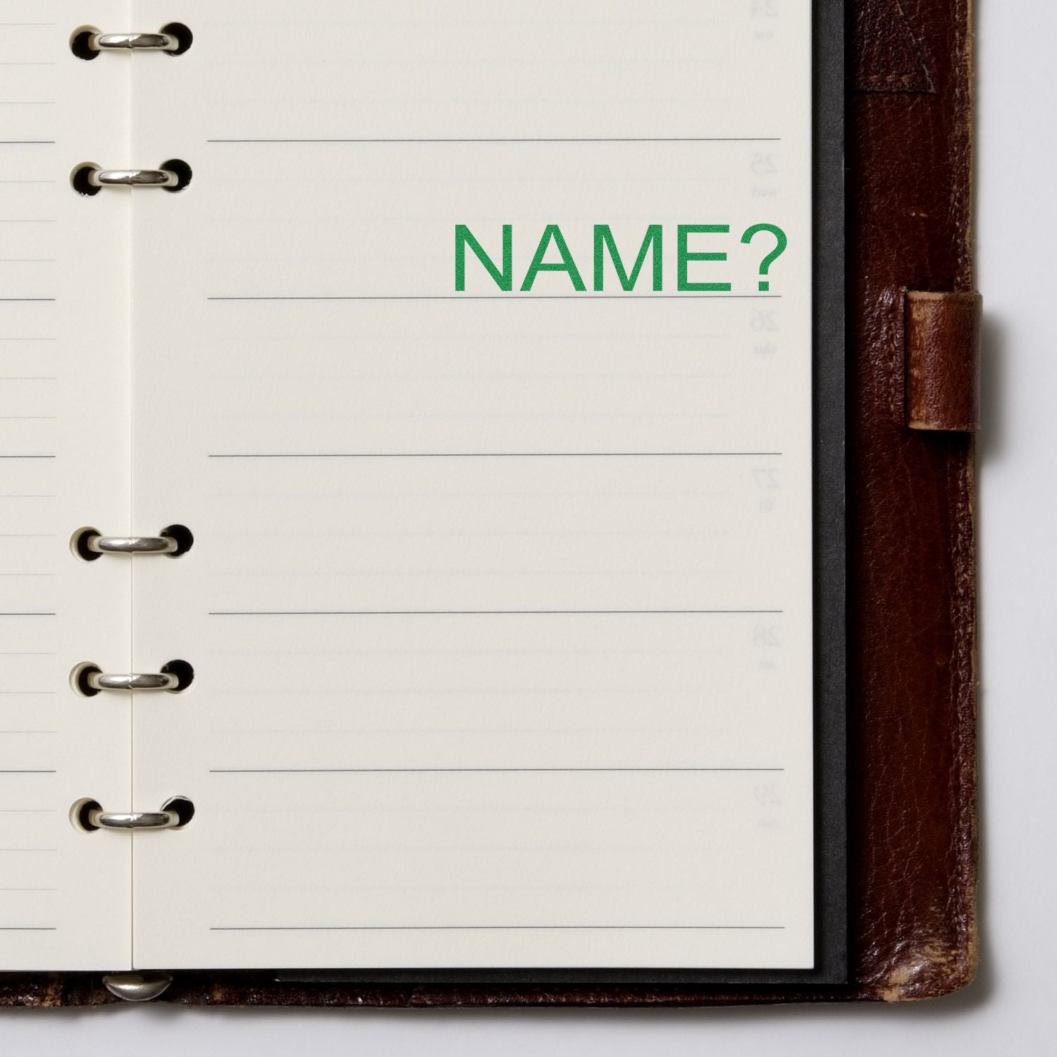 Open notebook with lined pages and a stamped green NAME? using the Large Pre-Inked Name Stamp, placed on the right side of the page.