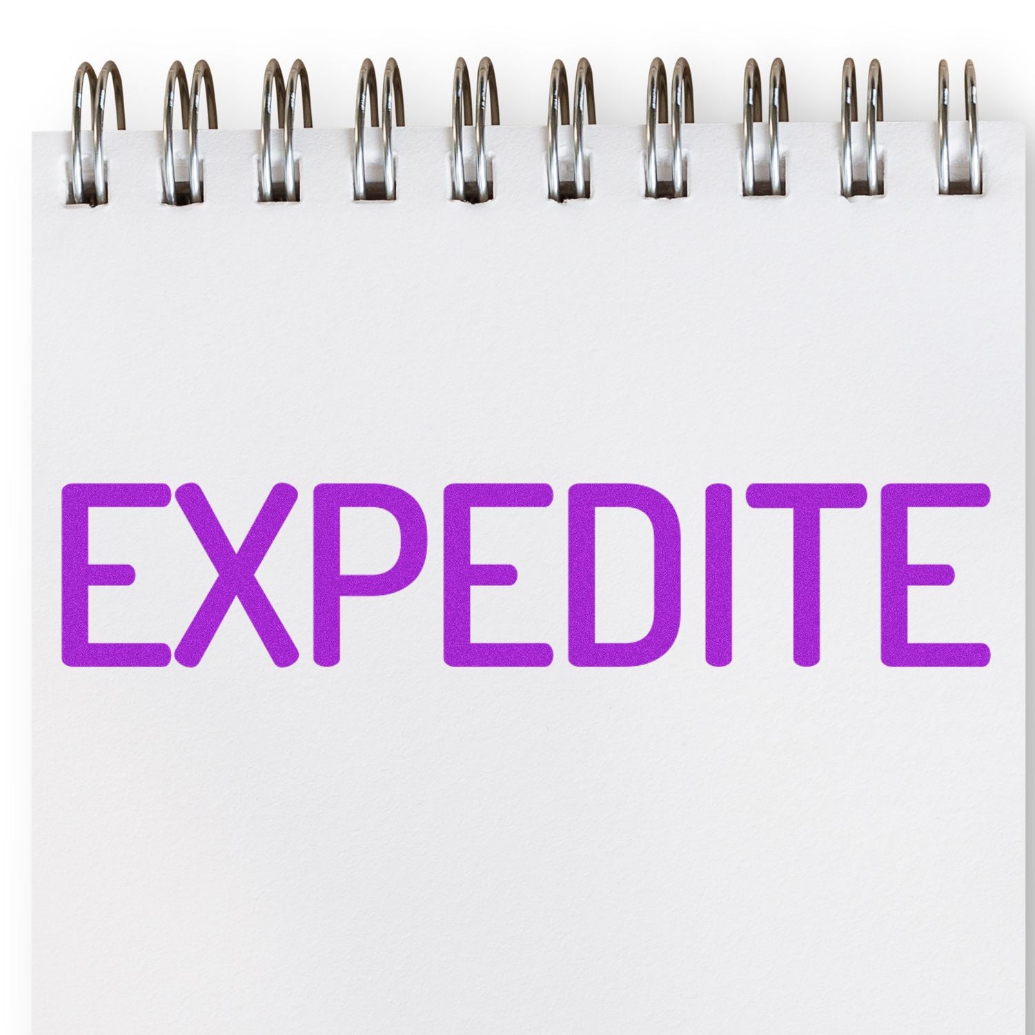 Large Self Inking Narrow Expedite Stamp imprinting the word 'EXPEDITE' in bold purple letters on a white spiral notebook.