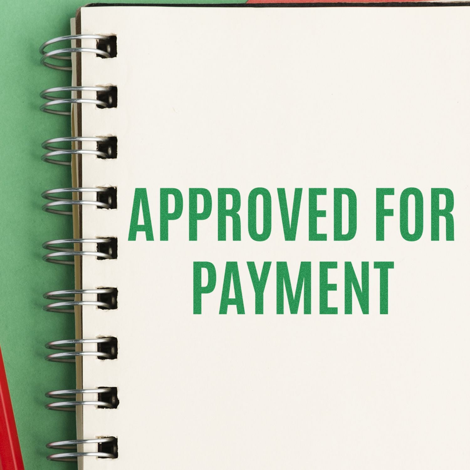 A notebook with "APPROVED FOR PAYMENT" stamped in green using the Narrow Font Approved for Payment Rubber Stamp.