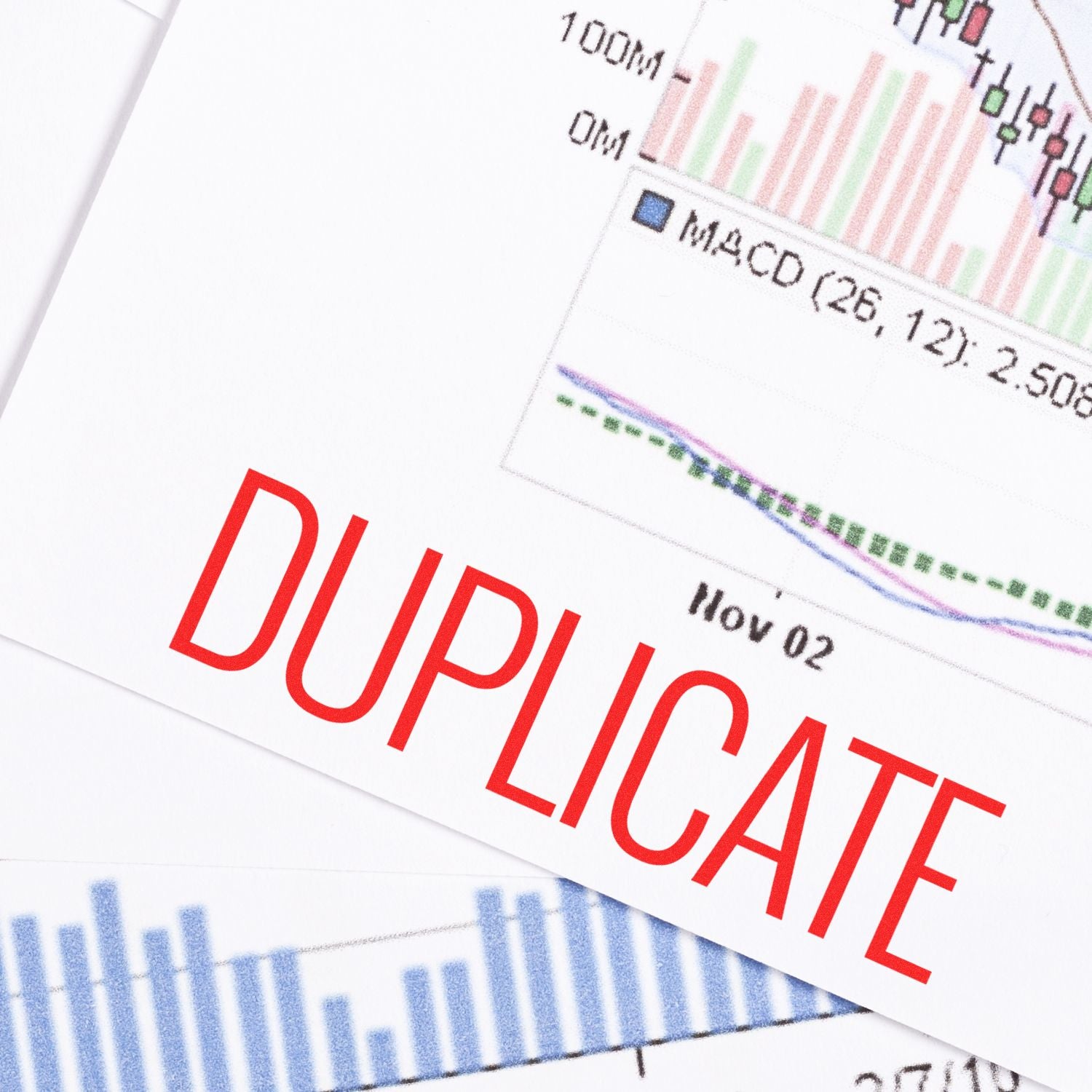 Narrow Font Duplicate Rubber Stamp in red ink on financial documents with charts and graphs in the background.