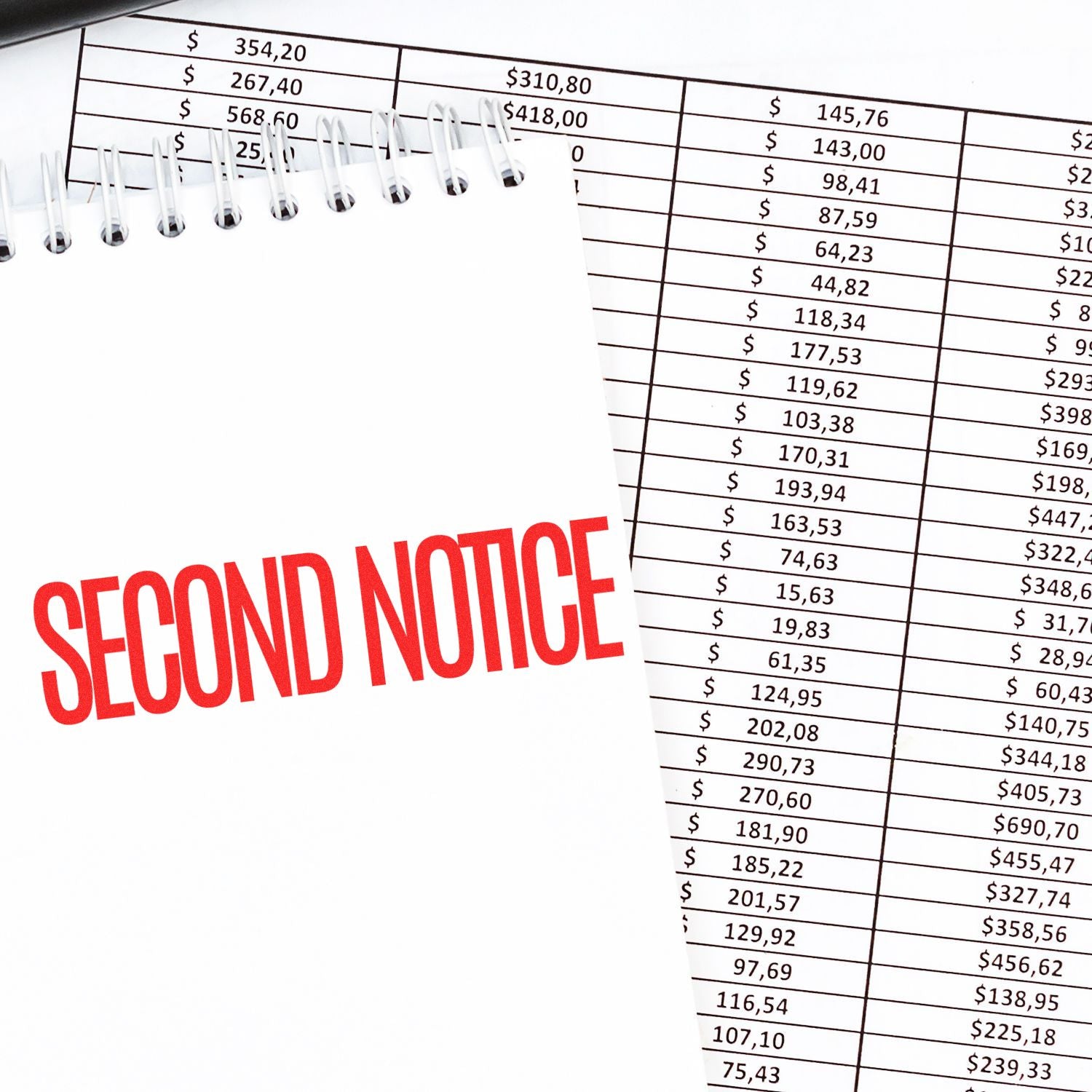 A notebook stamped with SECOND NOTICE in red using the Large Narrow Font Second Notice Rubber Stamp, placed on financial documents.