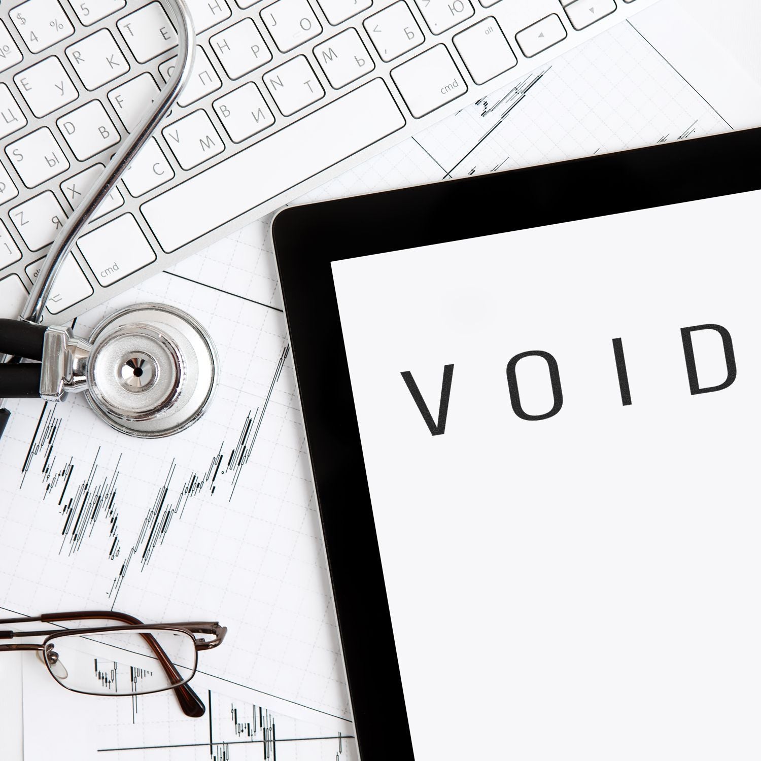 Large Self Inking Narrow Void Stamp in use on a document, surrounded by a keyboard, stethoscope, and glasses.