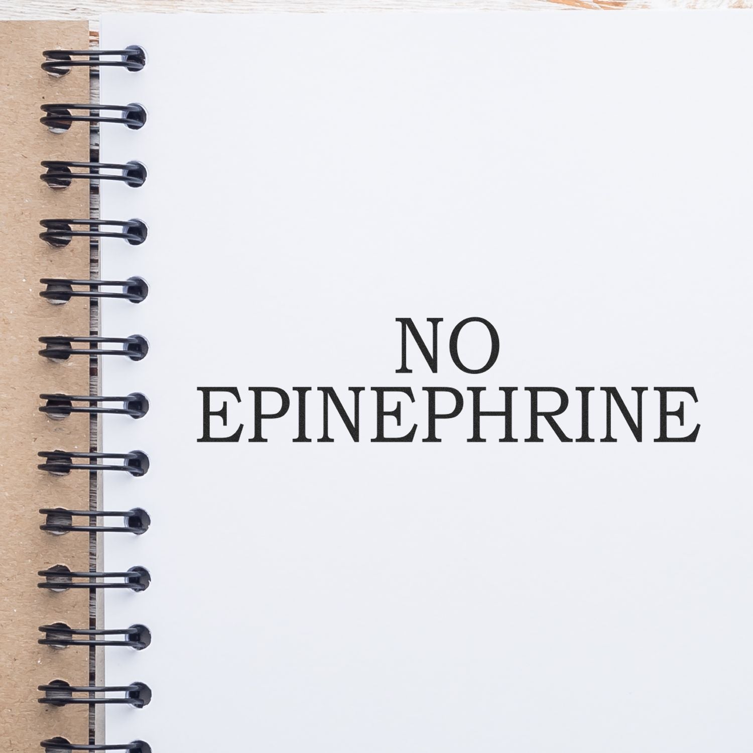 No Epinephrine Medical Rubber Stamp impression on a white notebook page with a spiral binding on the left side.