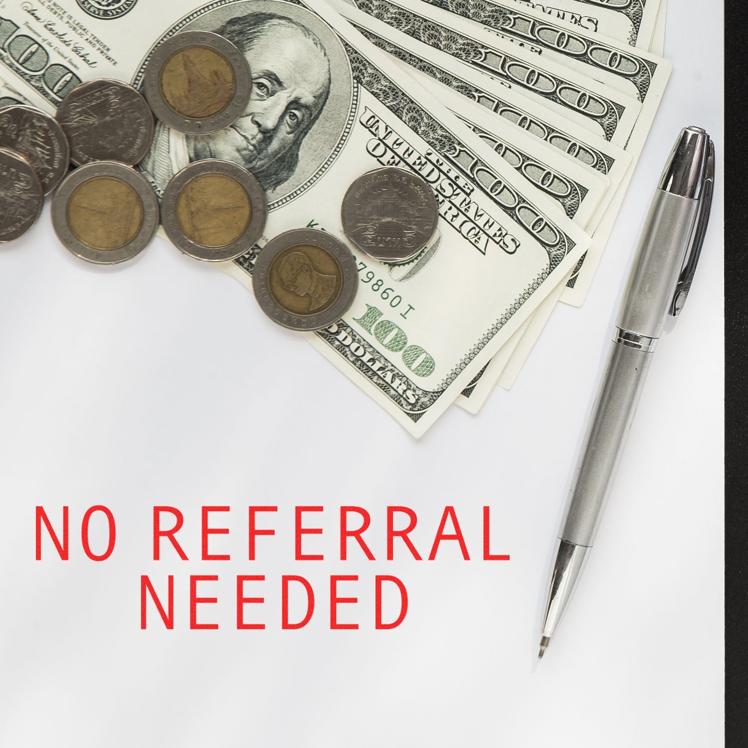 No Referral Needed Medical Rubber Stamp on paper with a pen, US dollar bills, and coins in the background.