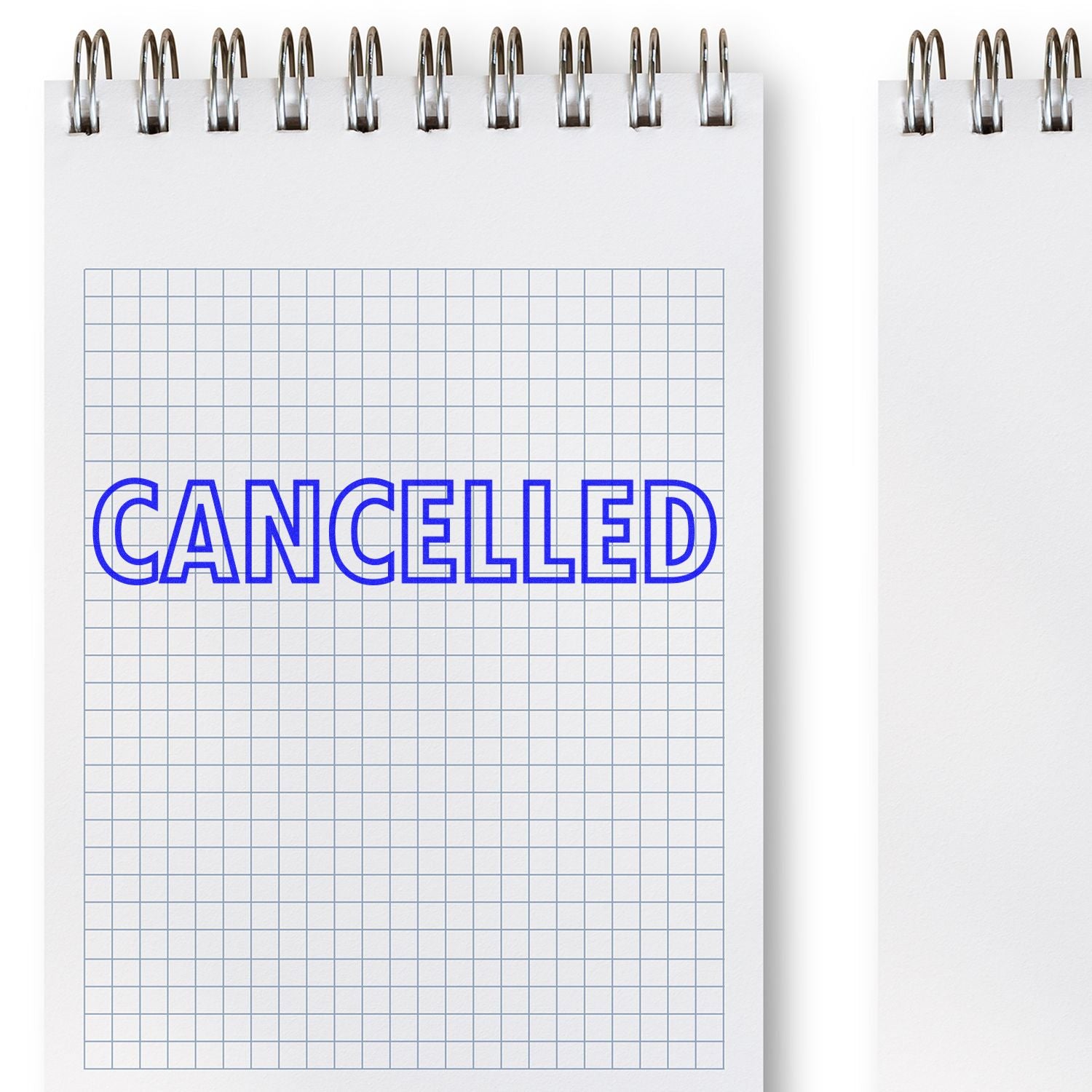 Outlined Cancelled Rubber Stamp in blue ink on a grid notebook page, with spiral binding visible at the top.