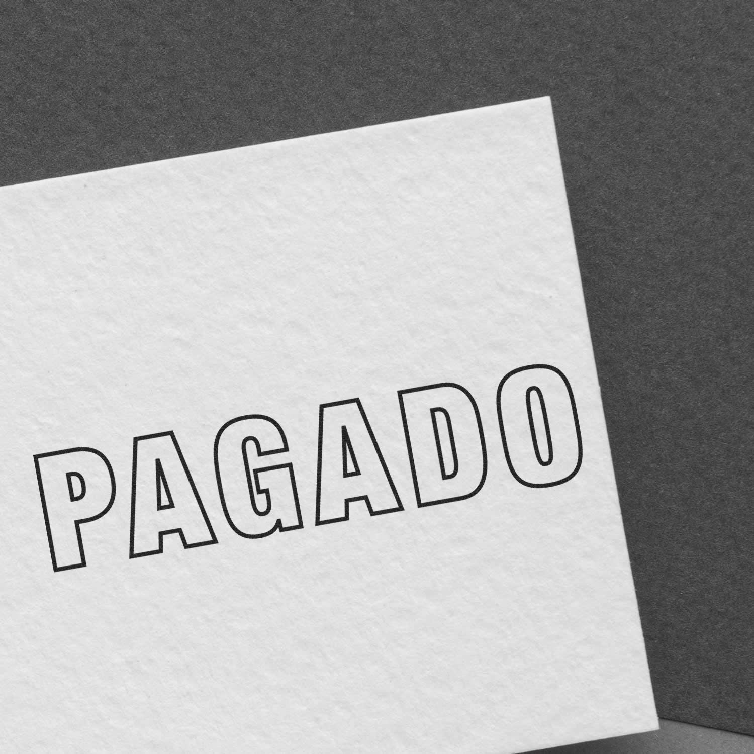 Large Outline Pagado Rubber Stamp imprint on white paper, displaying the word 'PAGADO' in bold, black, outlined letters.