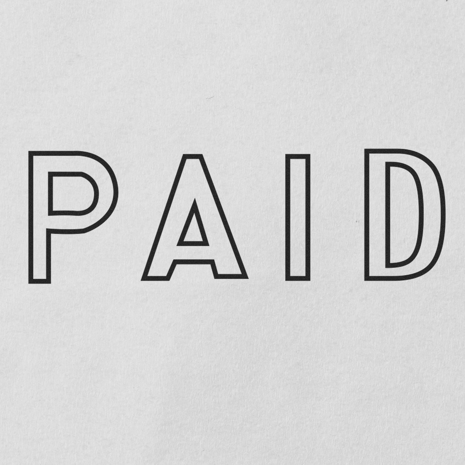 Outline Paid rubber stamp impression on white paper, showing the word 'PAID' in bold, outlined letters.