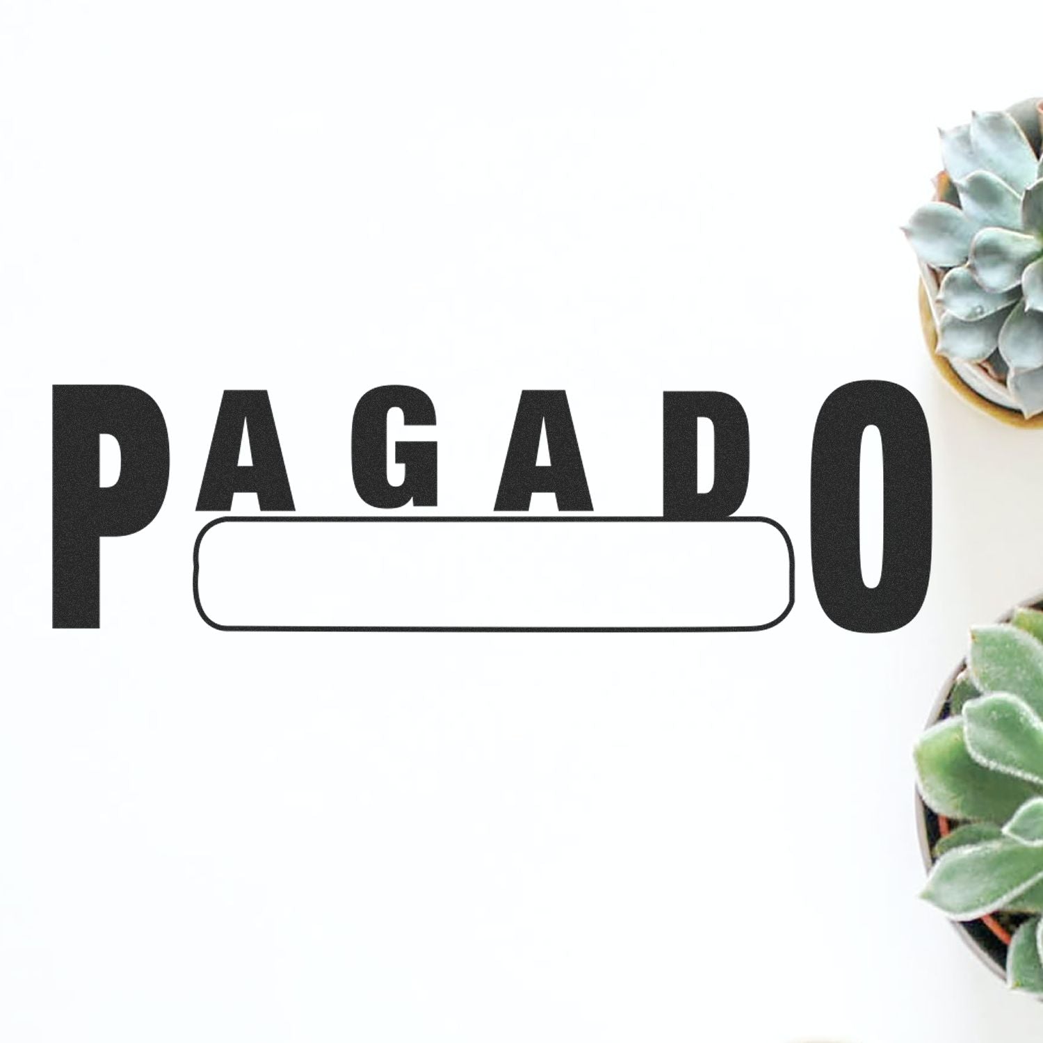 Large Pagado with Box Rubber Stamp in use, featuring bold 'PAGADO' text with a blank box, placed on a white surface with succulents.