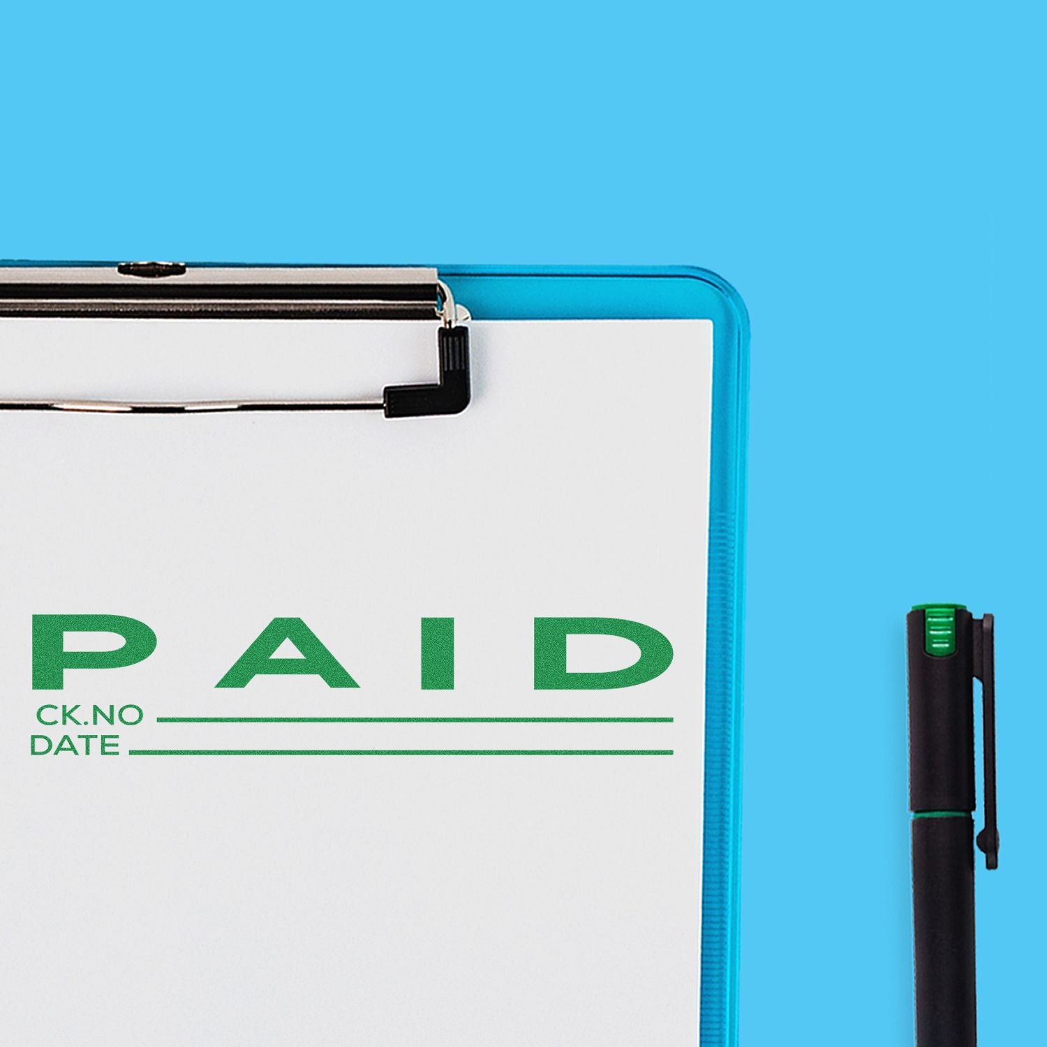 A clipboard with a Paid with Ck No Rubber Stamp imprint in green, alongside a black pen on a blue background.