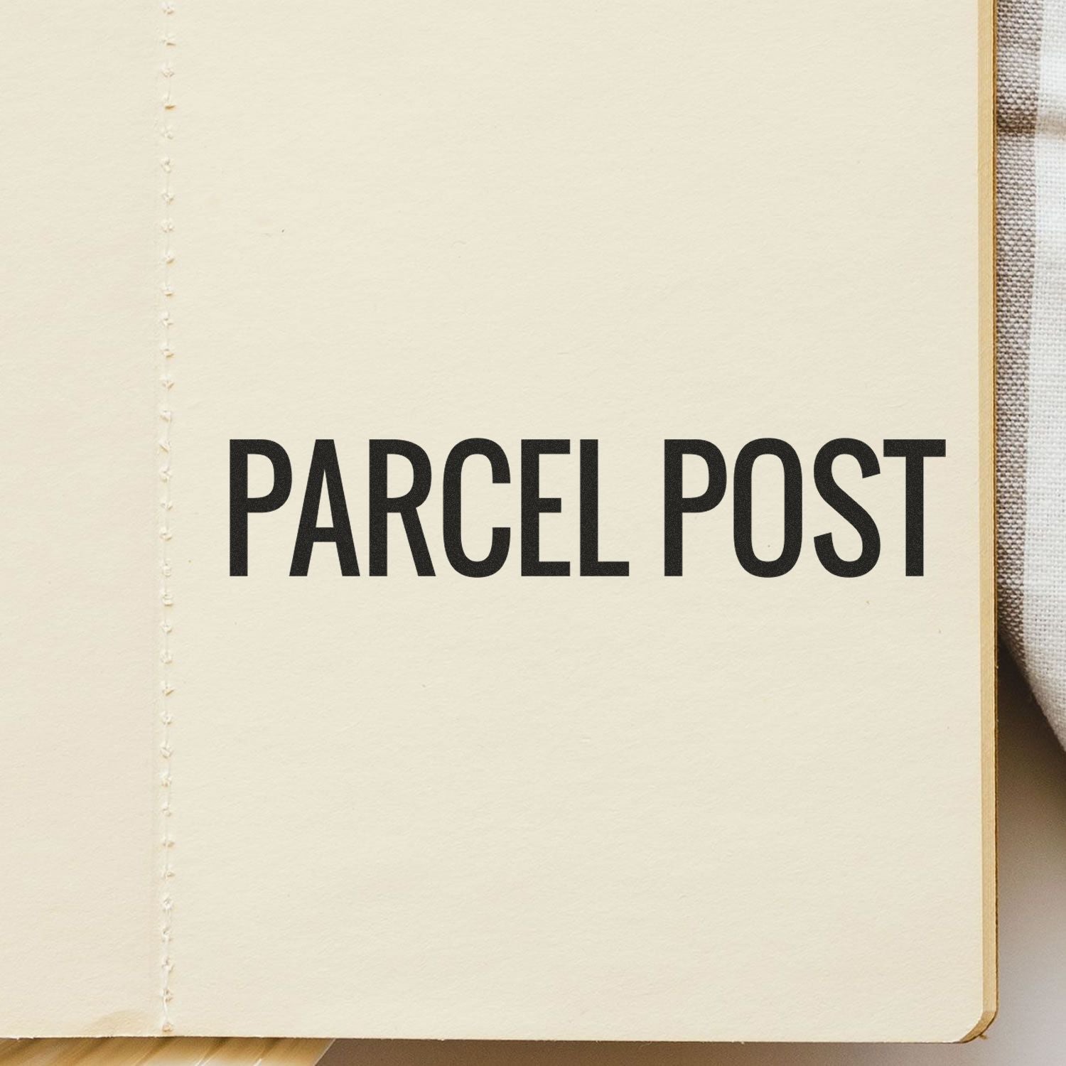 Large Pre-Inked Parcel Post Stamp imprint on a beige surface, displaying the text 'PARCEL POST' in bold black letters.