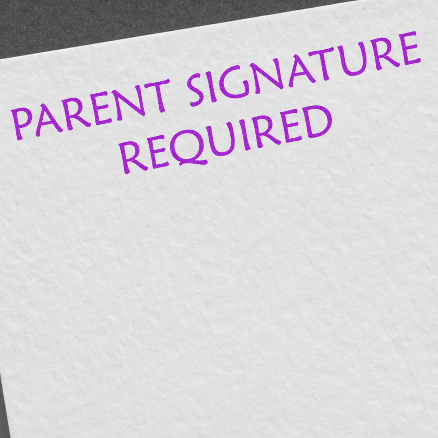 Parent Signature Required Rubber Stamp in use, displaying purple text on white paper.