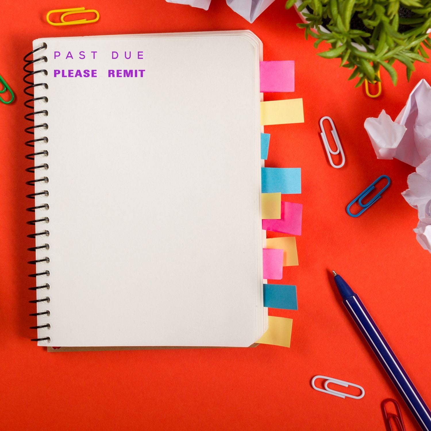 Notebook with sticky notes on a red desk, stamped with 'Past Due Please Remit' in purple and blue, surrounded by paper clips and a pen.