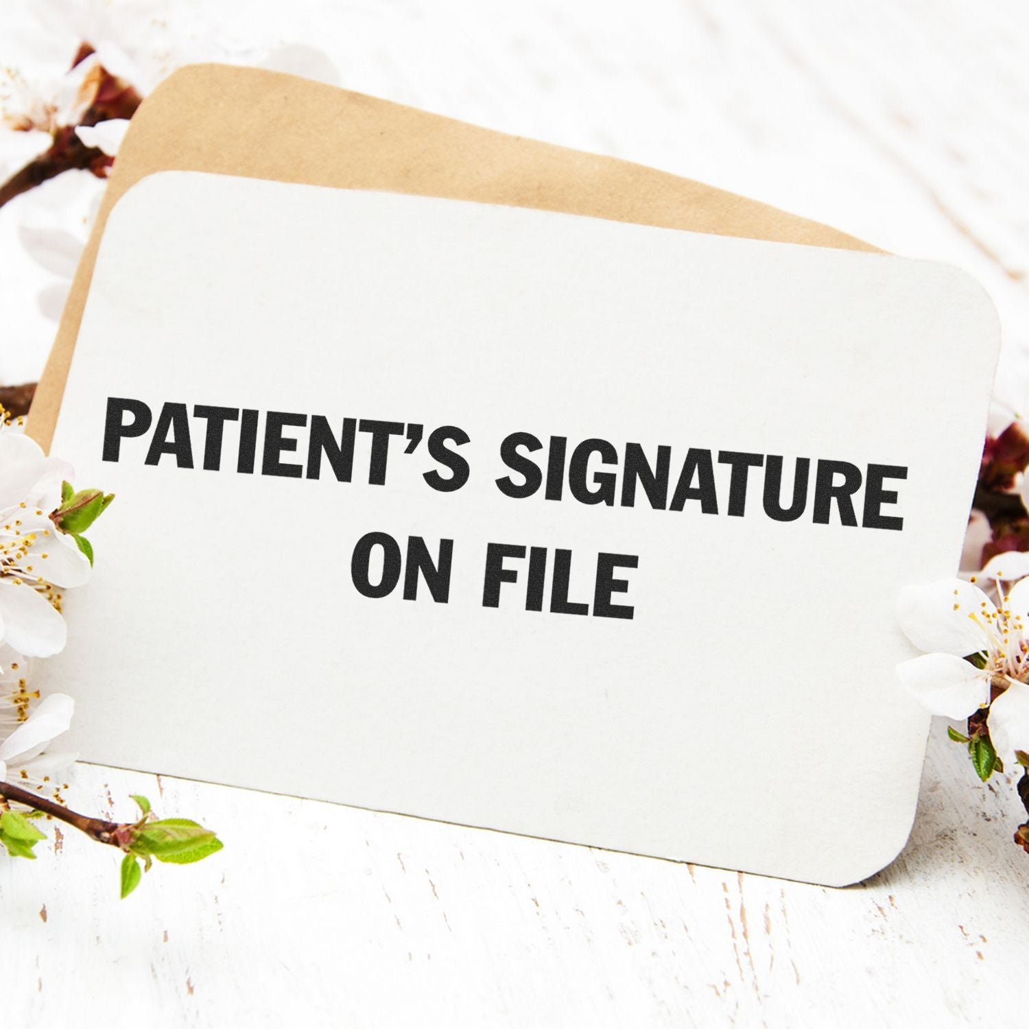 Slim Pre-Inked Patient's Signature on File Stamp used on a white card with flowers and an envelope in the background.