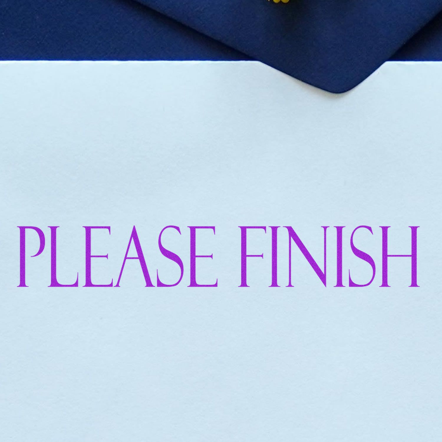 Large Self Inking Please Finish Stamp in use, displaying PLEASE FINISH in purple ink on a white paper with a dark blue background.