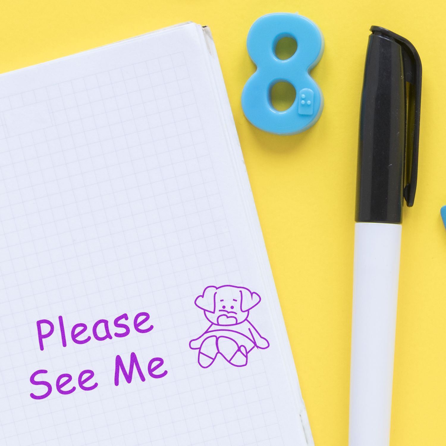 Please See Me Rubber Stamp on a notebook with a pen and number 8 magnet on a yellow background.