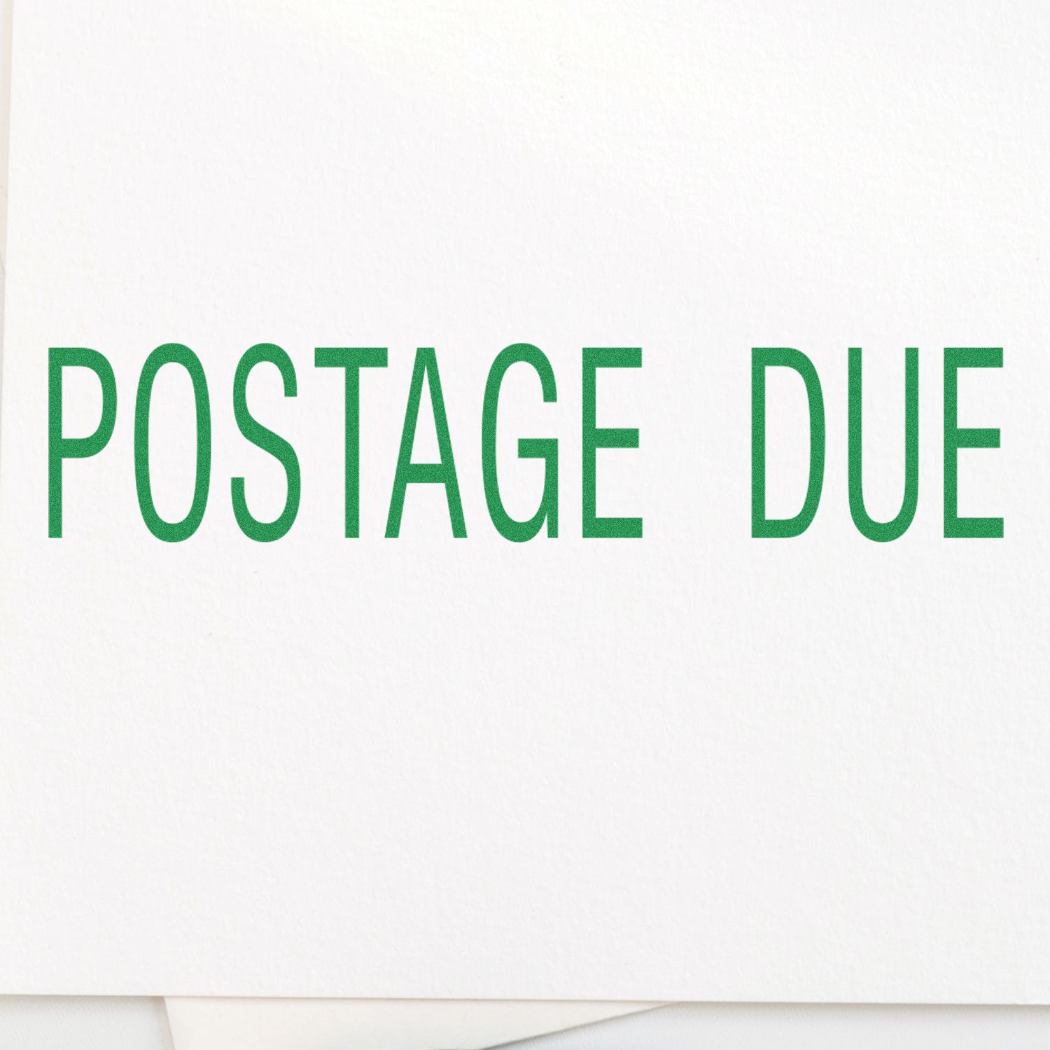 Green 'POSTAGE DUE' text stamped on white paper using a Self Inking Postage Due Stamp.