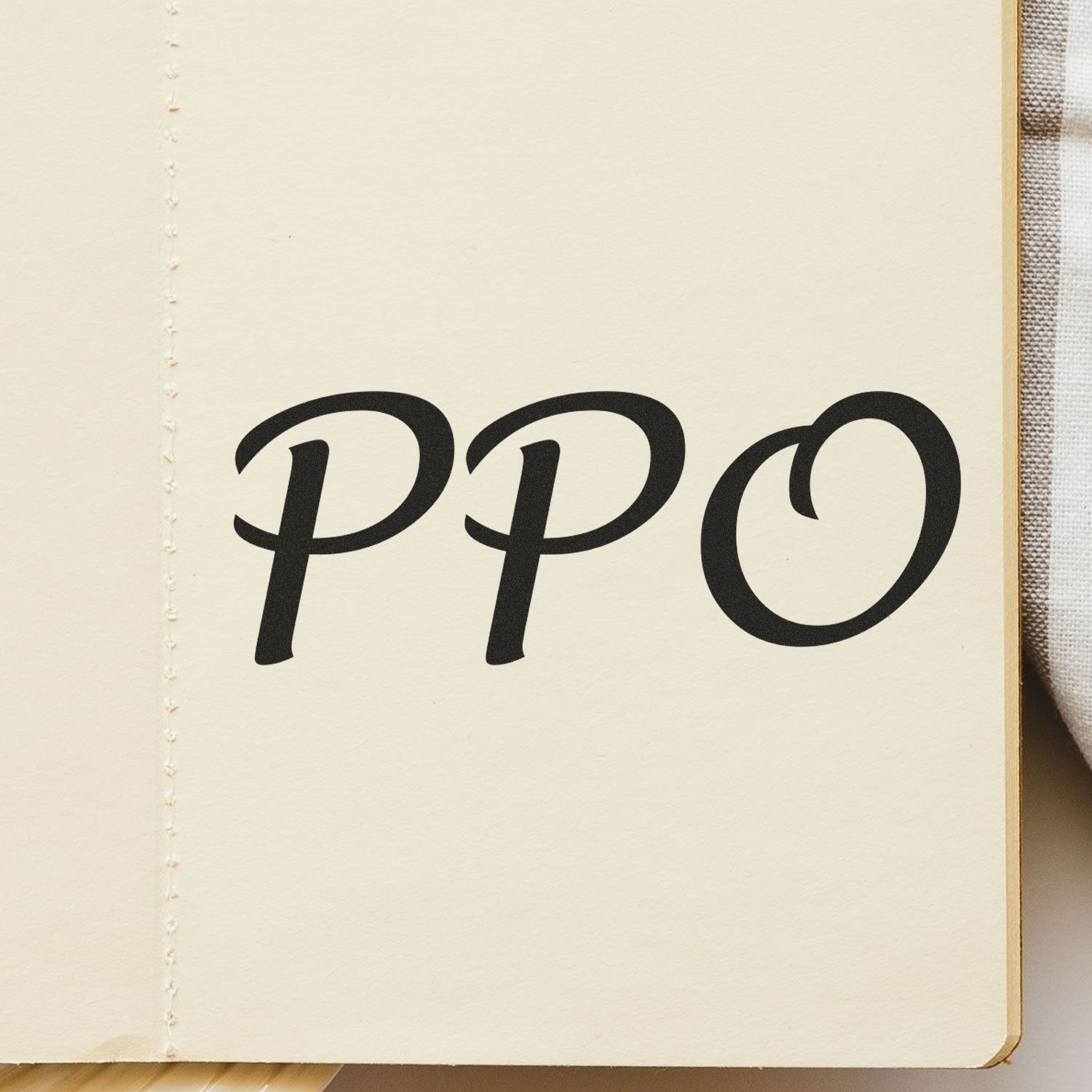 Large Pre-Inked PPO Stamp imprint on a cream-colored notebook page, showcasing bold, black 'PPO' text in a stylish font.