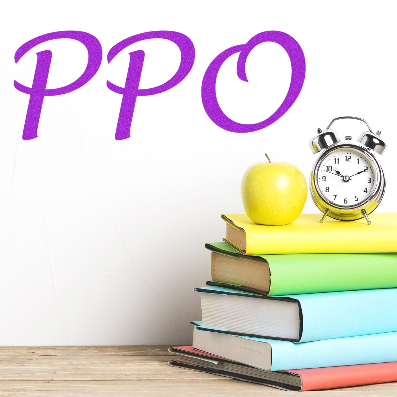 PPO Rubber Stamp on a white wall above a stack of colorful books with a green apple and an alarm clock on a wooden surface.