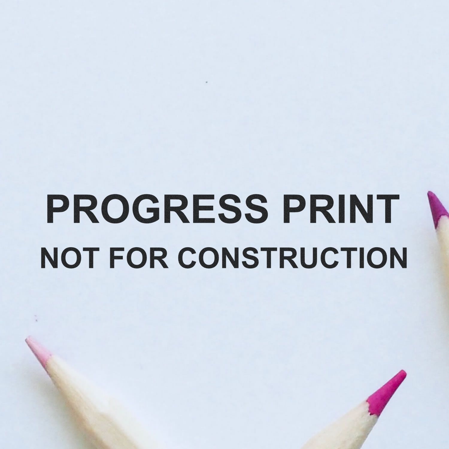 Self Inking Progress Print Stamp marking 'PROGRESS PRINT NOT FOR CONSTRUCTION' on paper, surrounded by three colored pencils.