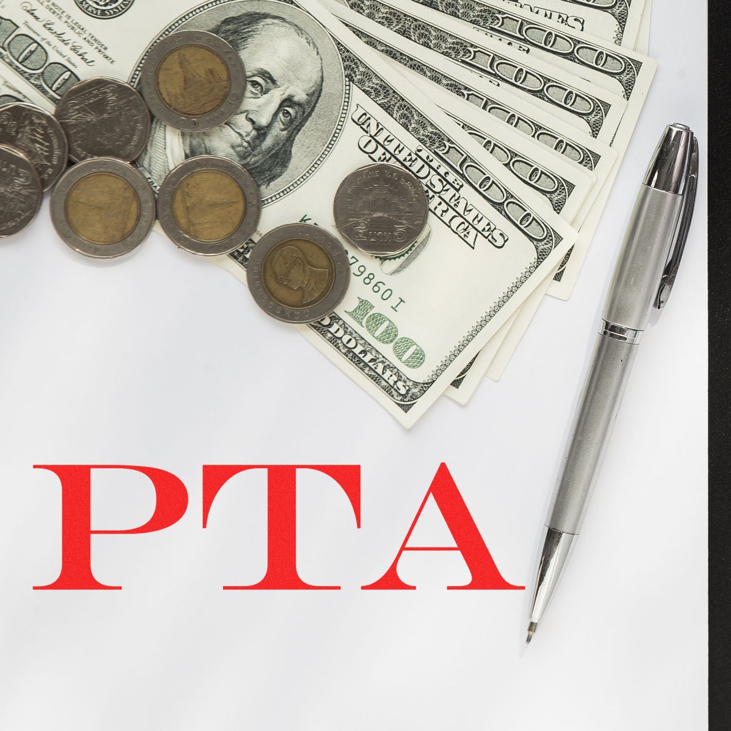 PTA Rubber Stamp on paper with a pen, coins, and dollar bills.