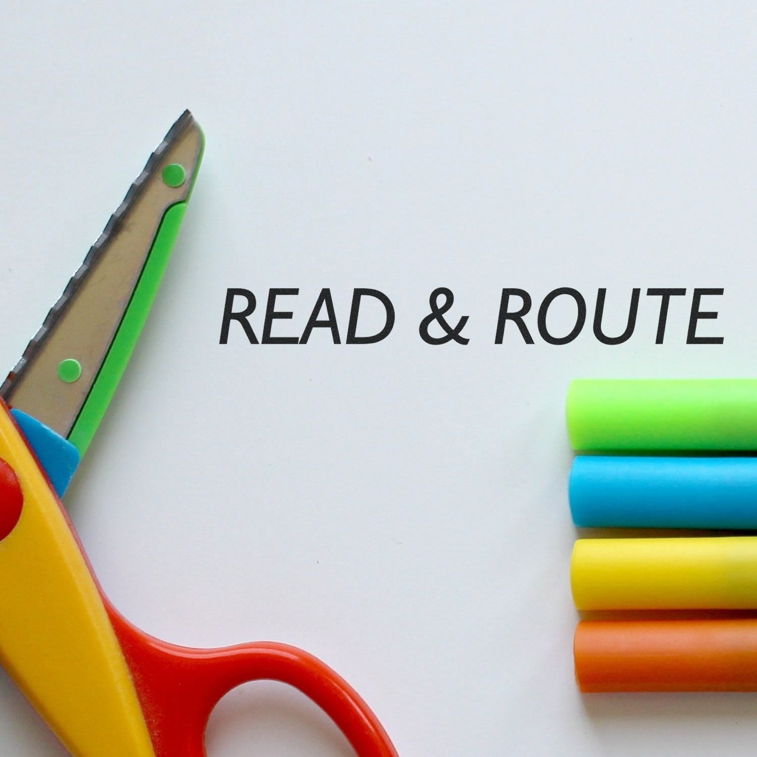 Read & Route rubber stamp with colorful markers and a pair of scissors on a white background.