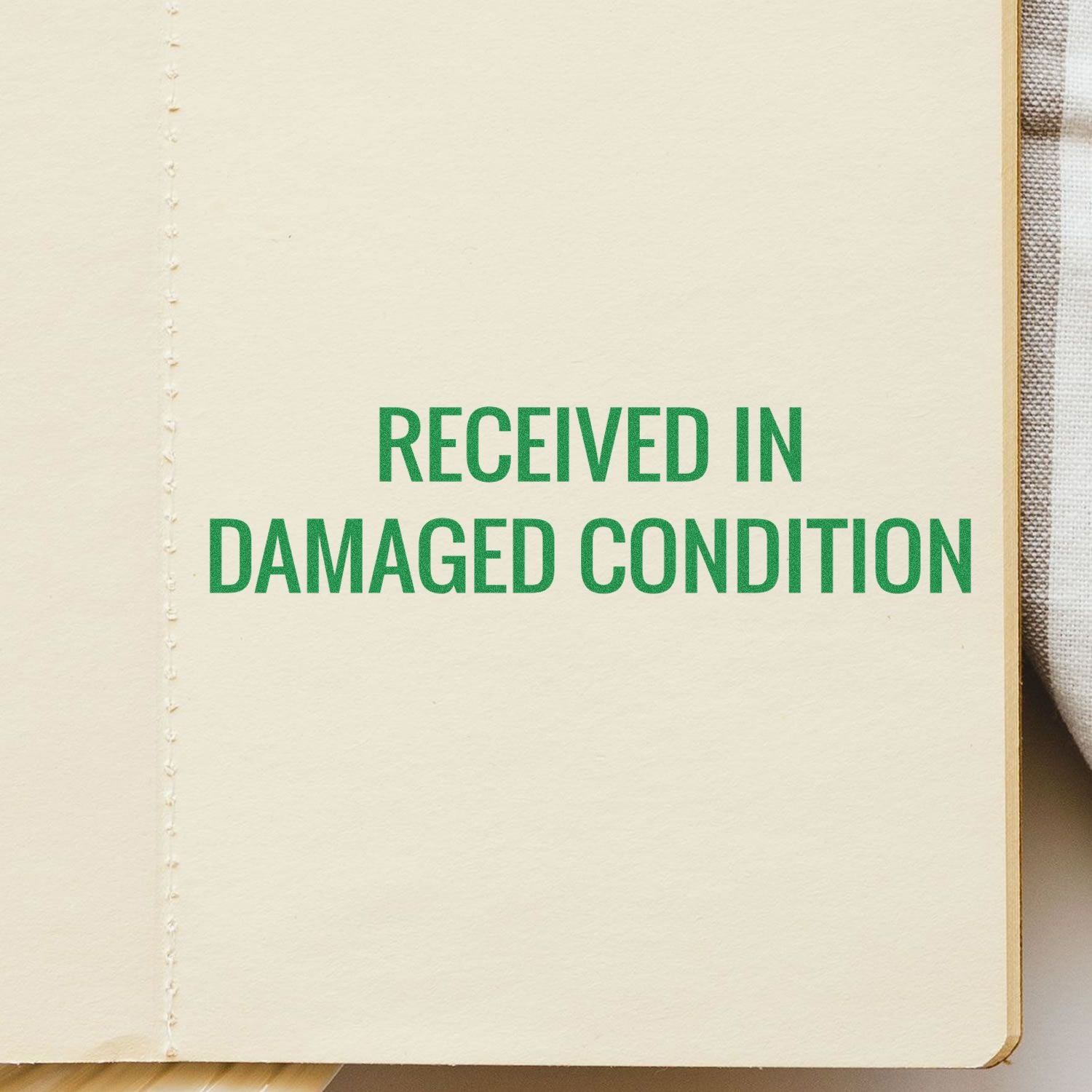 Large Received in Damaged Condition Rubber Stamp imprint in green ink on a beige paper background.