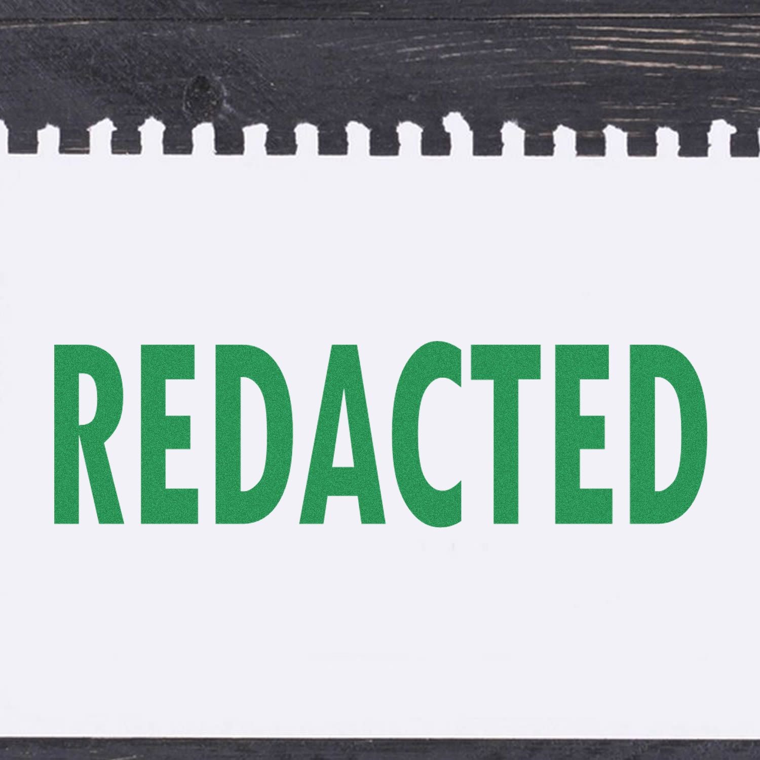 Redacted Rubber Stamp used on a white sheet of paper, displaying the word 'REDACTED' in bold green letters.