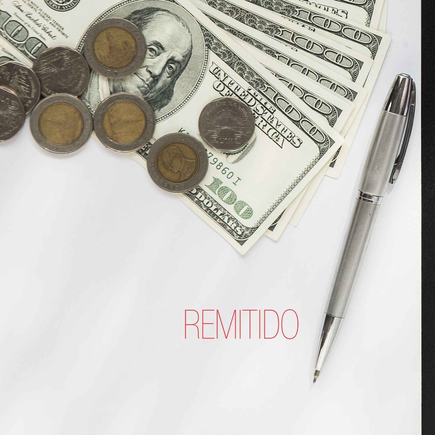 Large Self Inking Remitido Stamp used on paper with "REMITIDO" text, surrounded by a pen, coins, and US dollar bills.