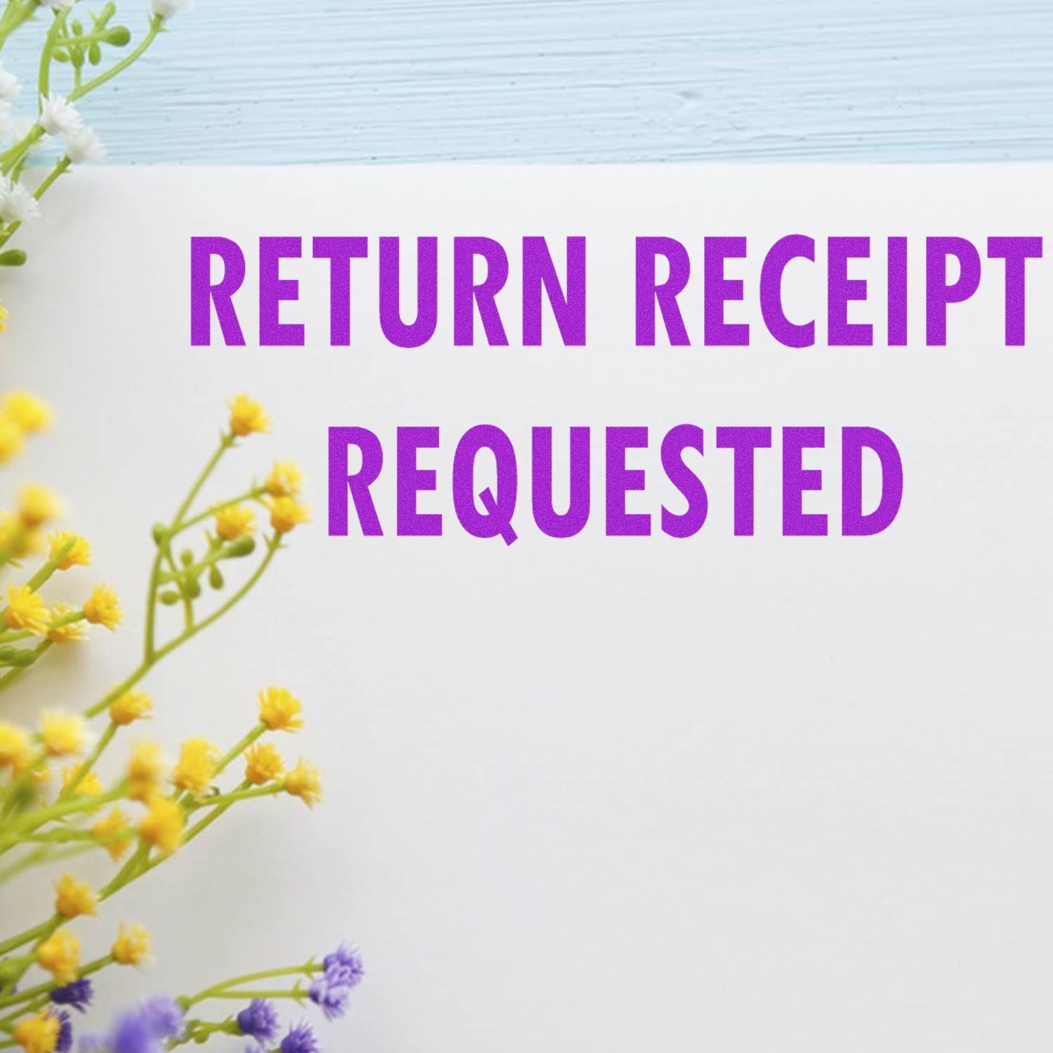 Self Inking Return Receipt Requested Stamp in use, showing the stamped text 'RETURN RECEIPT REQUESTED' in purple on white paper with flowers.