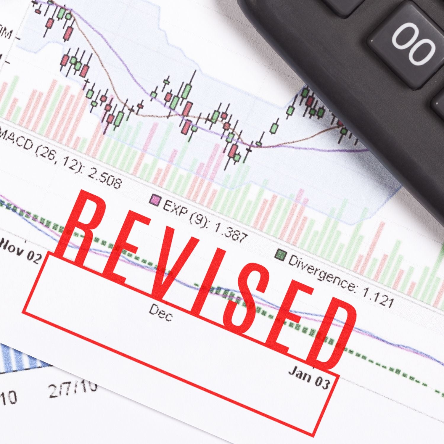 Large Self Inking Revised with Box Stamp marking a document with financial graphs and a keyboard in the background.