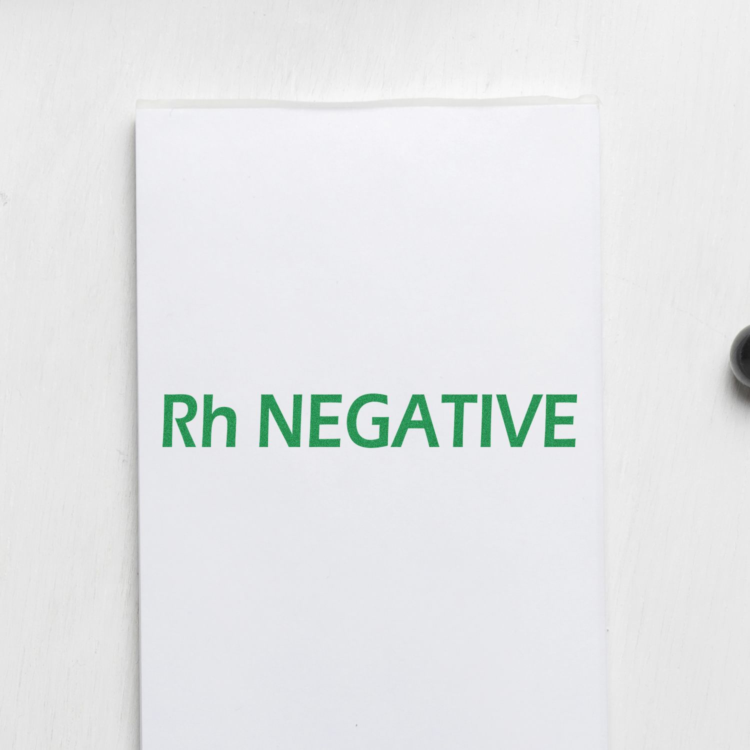 Slim Pre-Inked Rh Negative Stamp imprint in green ink on white paper, showcasing clear and bold text.