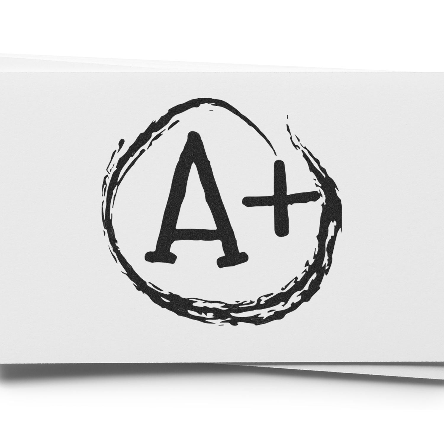 Round A+ rubber stamp in black ink on white paper, with a circular brushstroke design surrounding the A+ symbol.