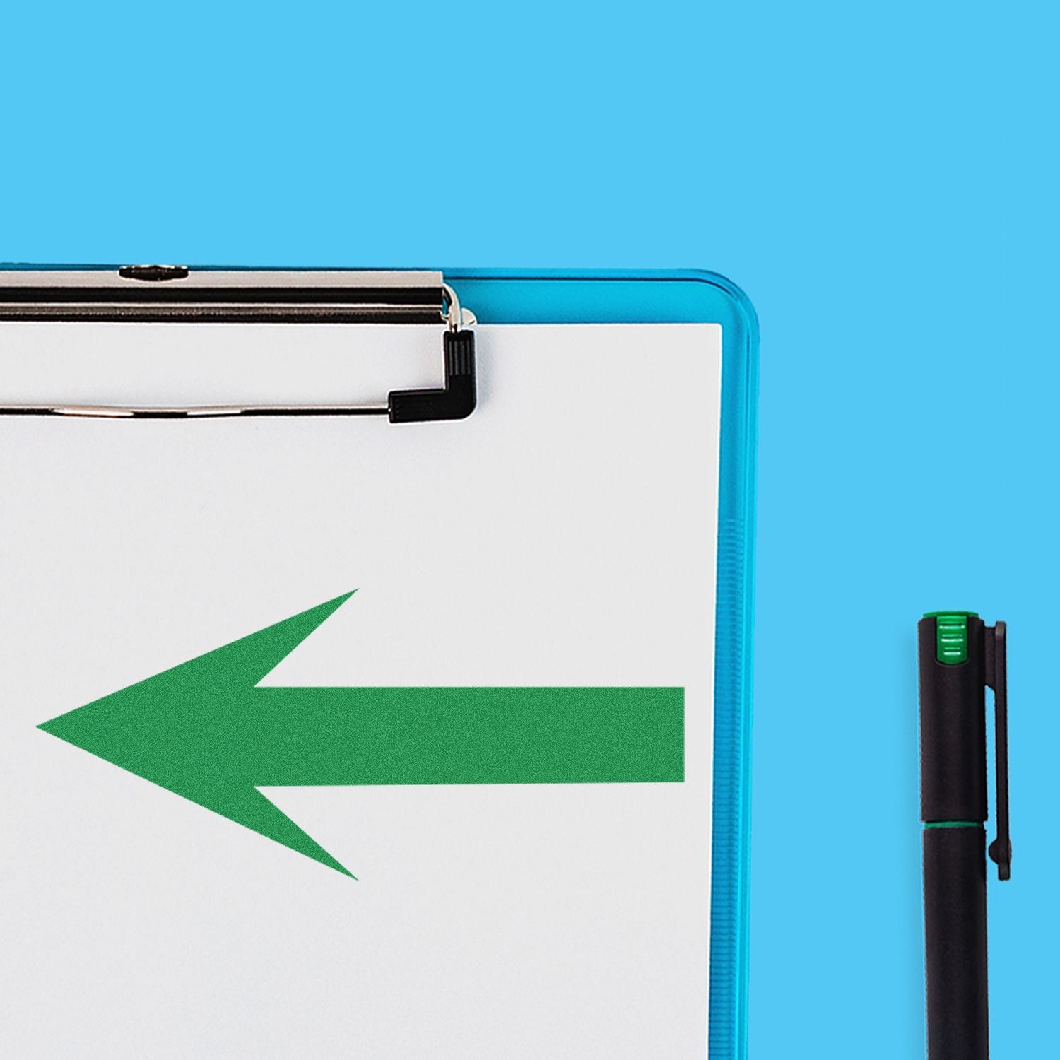 Clipboard with a green round arrow rubber stamp pointing left, placed on a blue background next to a black pen.