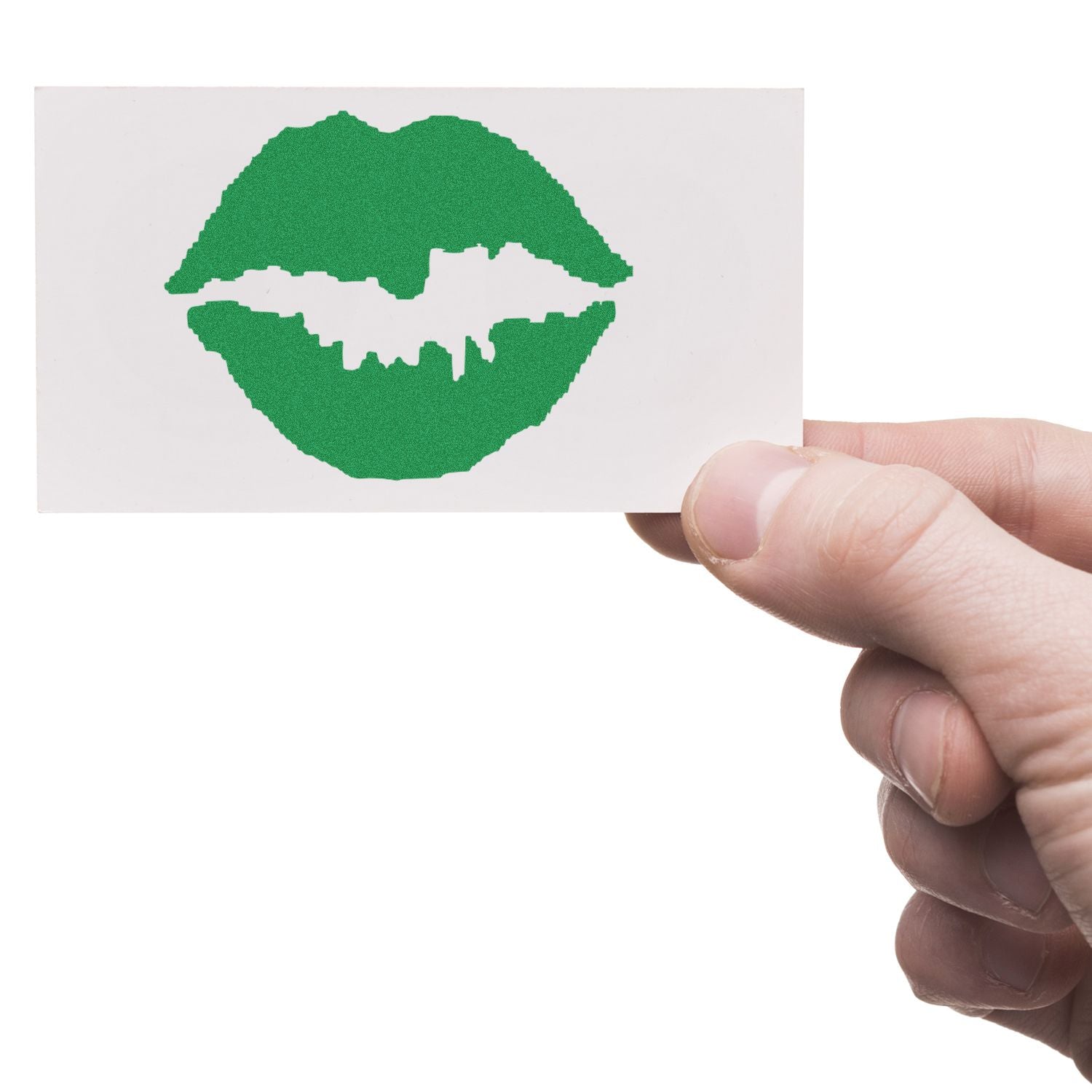 A hand holding a white card with a green Round Kiss Rubber Stamp imprint of lips in the center.