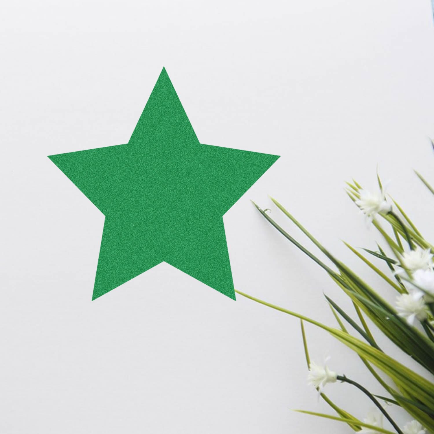 Round Solid Star Rubber Stamp in use, creating a green star imprint on white paper, with green plants in the background.