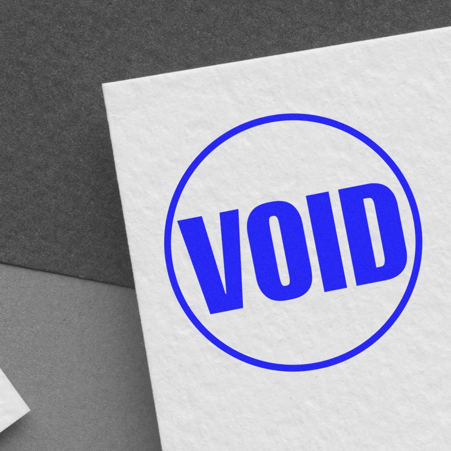 Round Void Rubber Stamp imprint in blue ink on a white paper, showing the word "VOID" inside a circle.