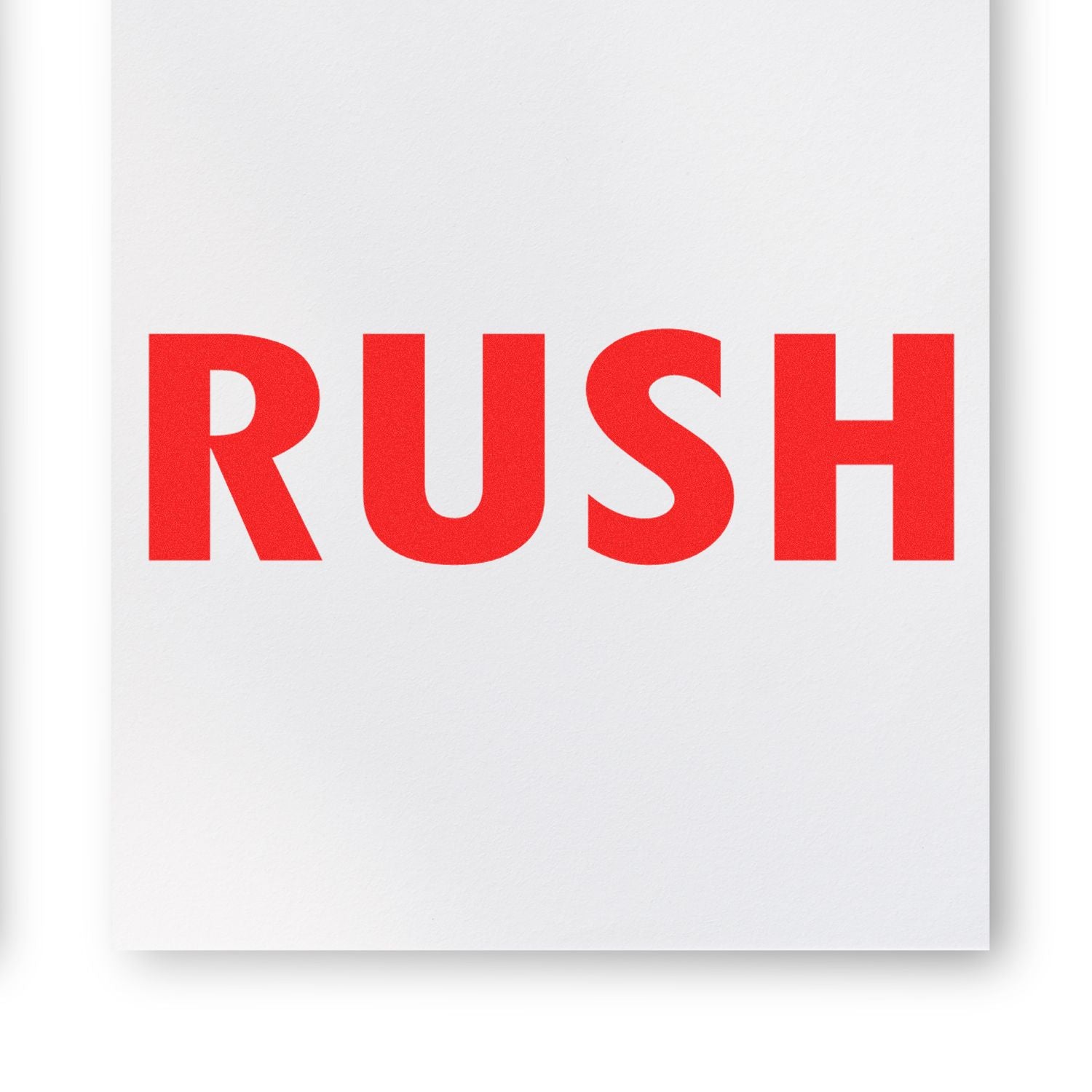 Red 'RUSH' text stamped on white paper using the Rush Rubber Stamp, indicating urgency or priority.