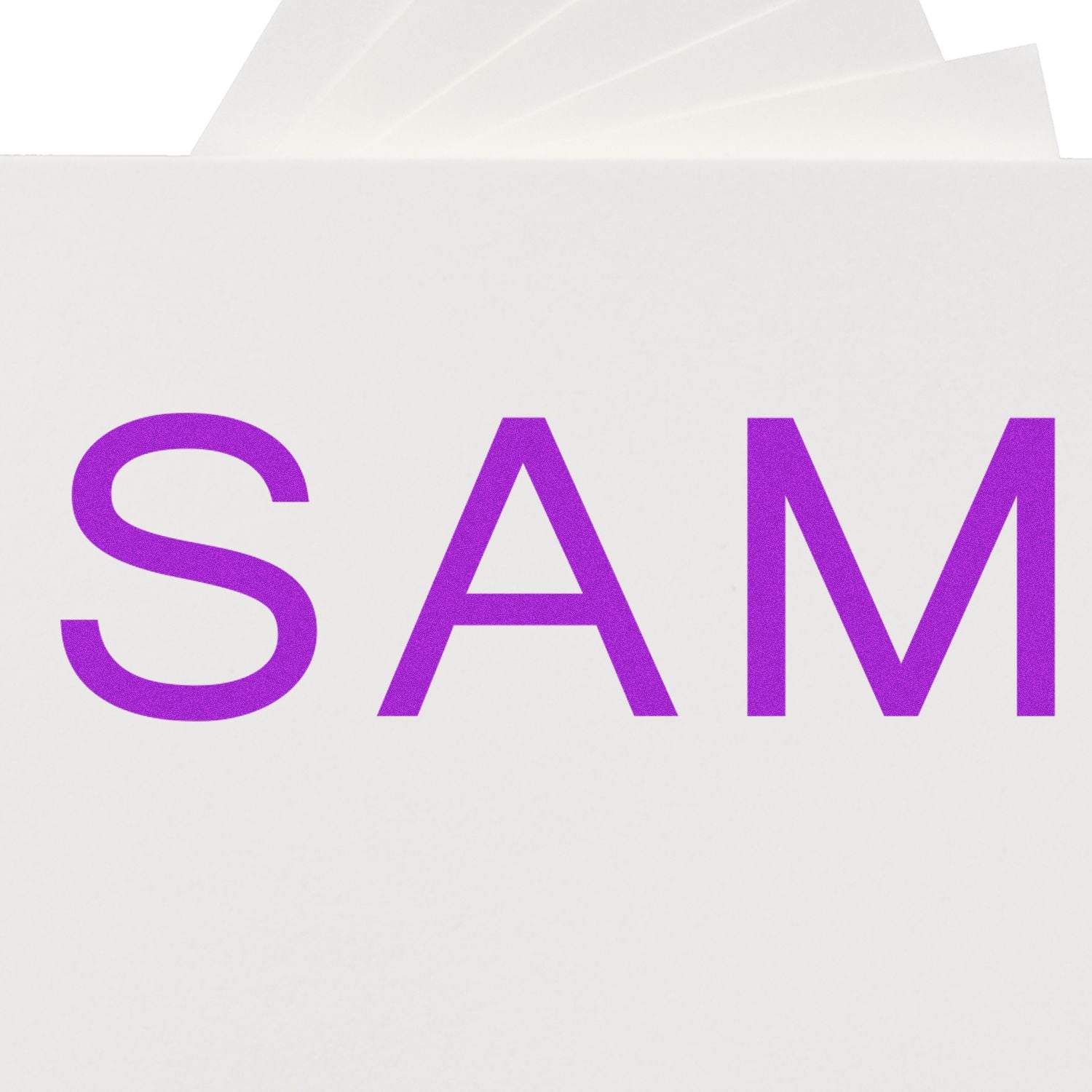 Large Self Inking SAM Stamp in use, showing the word SAM stamped in purple ink on white paper.