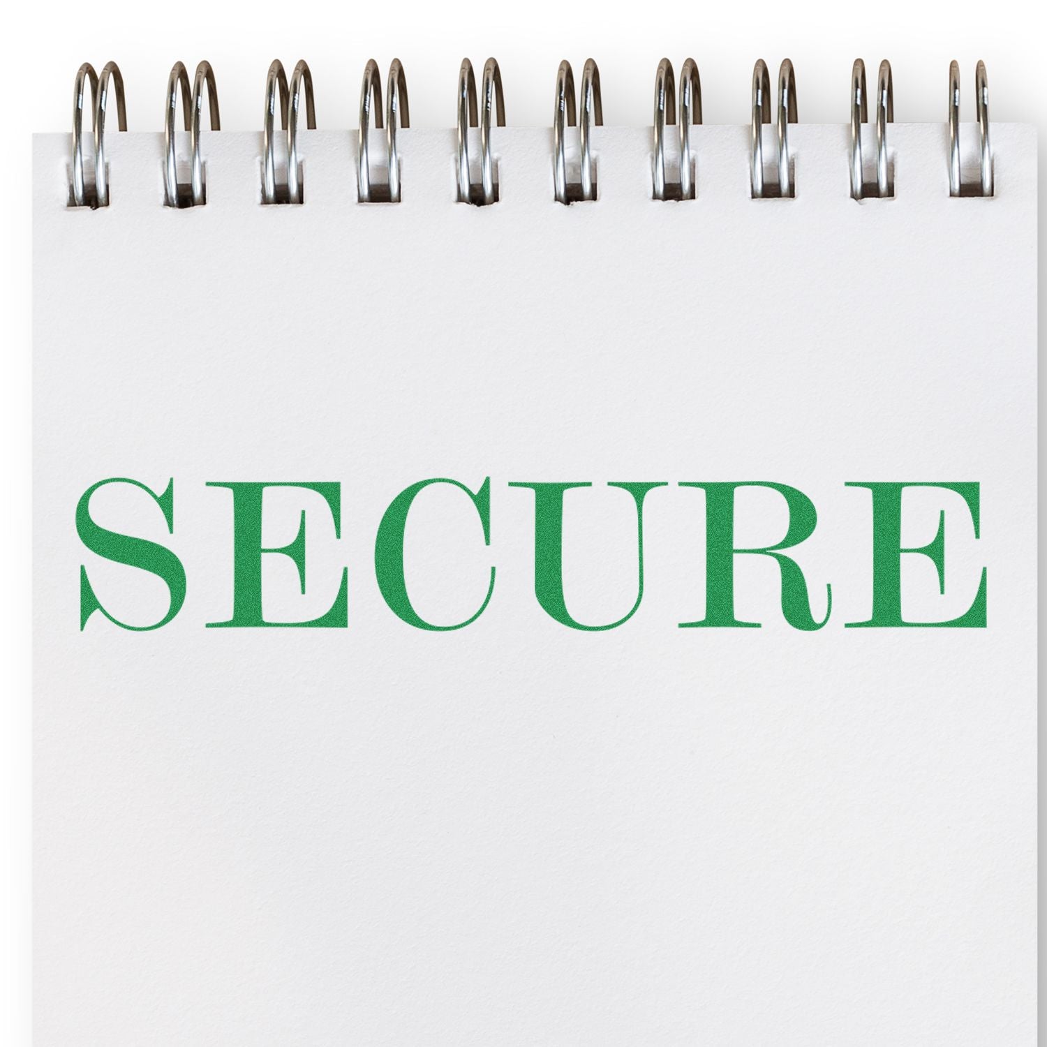 A Secure Rubber Stamp imprint on a white notepad with a spiral binding, displaying the word "SECURE" in green capital letters.